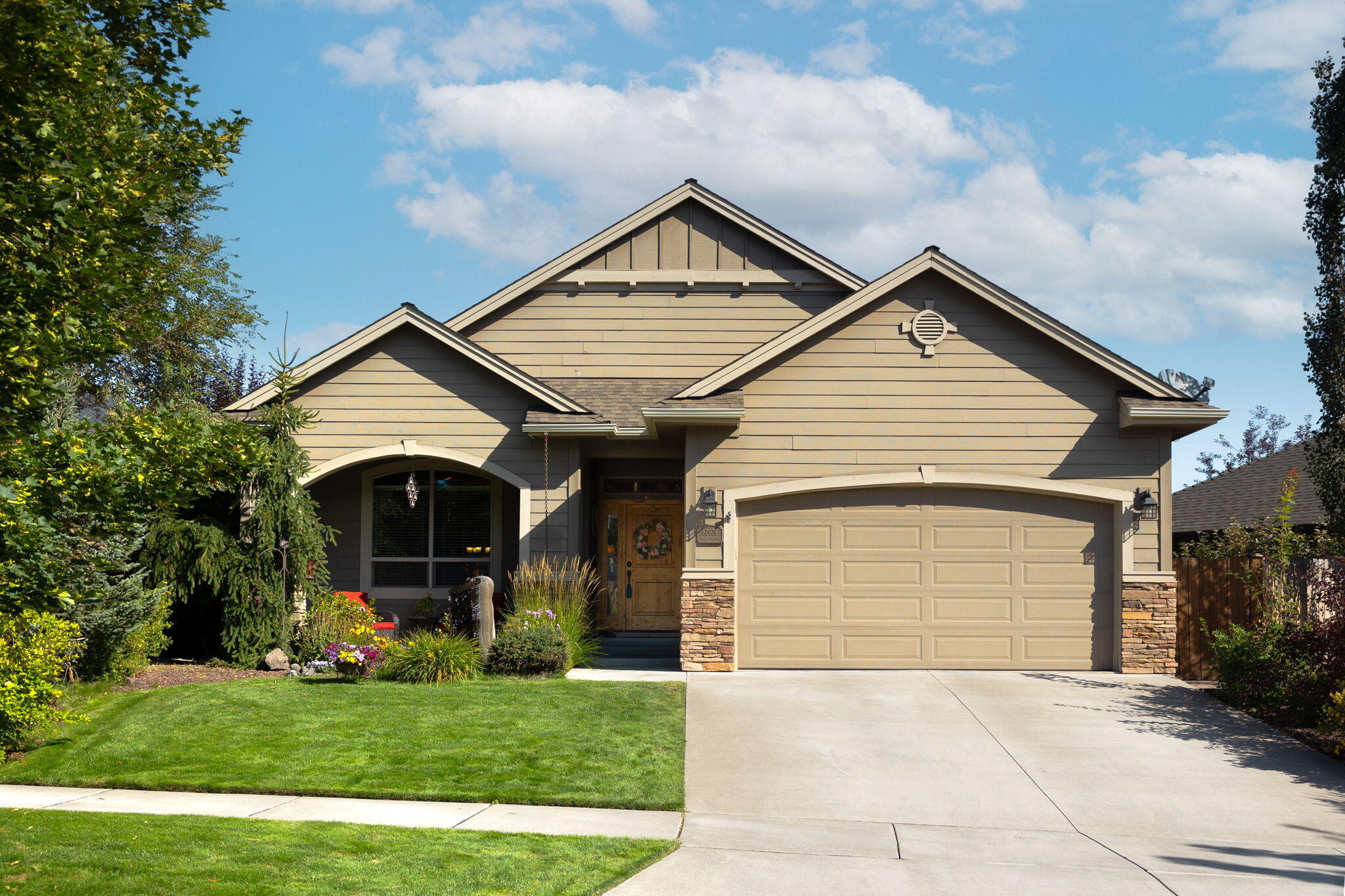 Welcome to 60974 Grand Targhee Drive in SE Bend. This gorgeous single level gem is nestled in a great neighborhood, and will soon have a new Park in close proximity (https://www.bendparksandrec.org/project/project155/). The interior includes a vaulted living room ceiling, floor to ceiling rock fireplace, windows lining the dining room and living room, and custom cabinets in the kitchen with an island eating bar. The spacious primary suite is also vaulted, and has a walk-in closet. The exterior includes covered front and back porches, a tranquil backyard setting for you to entertain, retreat, or enjoy all the benefits of your very own hot tub. Beautifully landscaped, this home exudes Pride of Ownership from the moment you set eyes on it. Don't miss out on this amazing opportunity. Schedule your showing today!