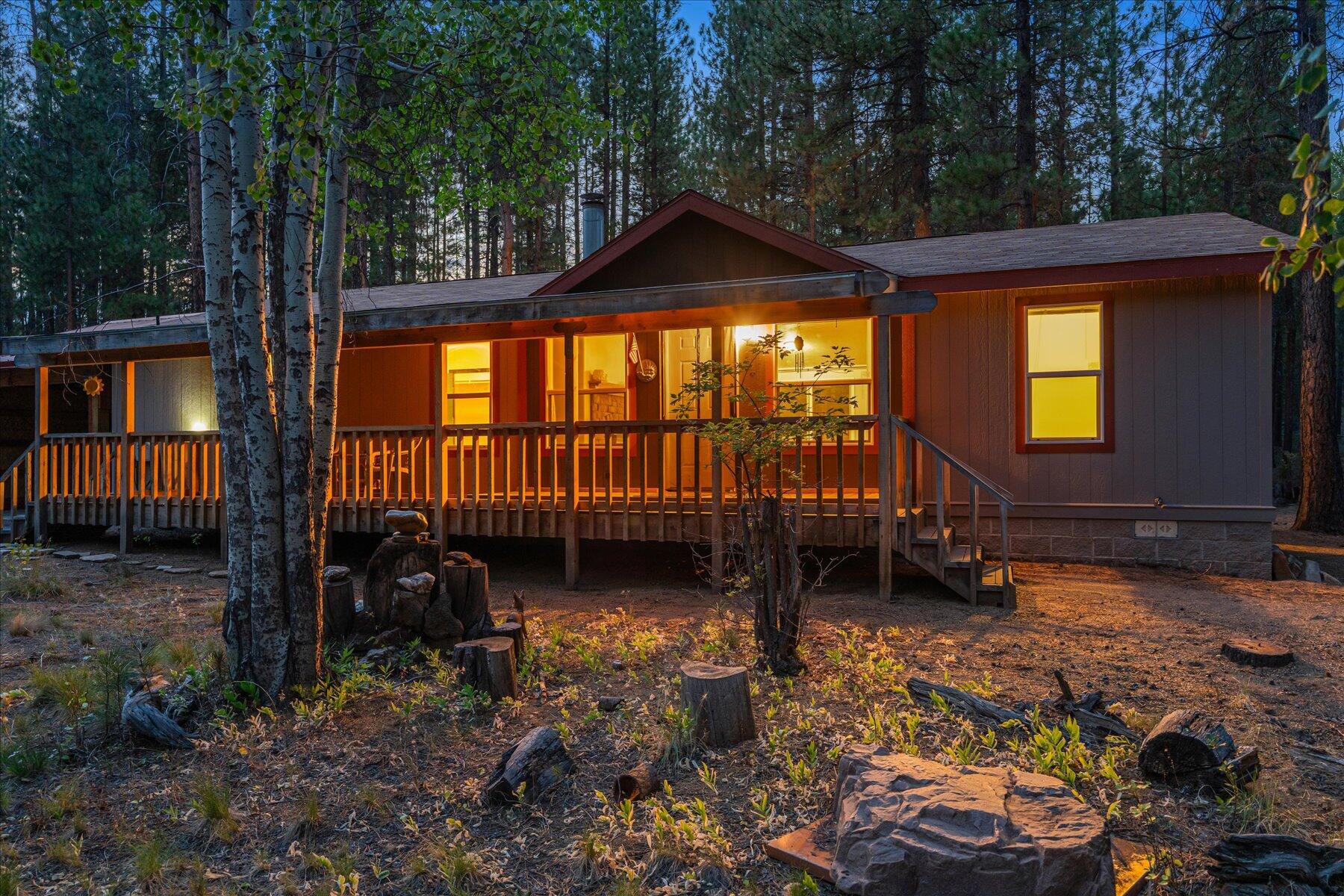 Discover the perfect blend of privacy, nature, and convenience with this delightful 3-bedroom, 2-bath charmer nestled on a spacious 0.75-acre wooded lot near the end of a cul-de-sac. Located in the sought-after Deschutes River Recreation neighborhood, this property backs directly onto Deschutes National Forest land—offering endless outdoor adventure right out your back door, with quick access to non-motorized walking, hiking, snowshoeing and cross-country skiing. Enjoy the peaceful surroundings from your paved circular driveway and take advantage of two concrete carports plus RV hookups—ideal for guests or your next adventure basecamp. Whether you're looking for a full-time residence, vacation getaway, or investment property, this location is unbeatable—just minutes from Sunriver's endless amenities and with quick access to the Deschutes River, Cascade Lakes and Mt. Bachelor. Don't miss this rare opportunity to own your own slice of Central Oregon paradise!