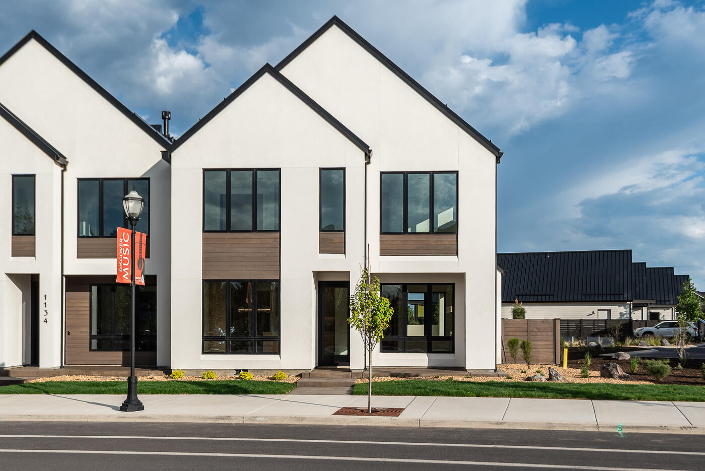 Scandinavian-inspired modern design with the award-winning craftsmanship of Structure Development NW in Discovery West. Trove Townhomes blend clean lines, contemporary finishes, and an open-concept layout, offering extraordinary living spaces. Great room with gas fireplace, custom built-ins and hardwood floors. Kitchen features professional appliances, large island and pantry. Dining area and covered patio are perfect for entertaining. The upper floor is highlighted by a stunning primary suite with vaulted ceilings, tile shower, radiant floors and a large walk-in closet. Two additional bedrooms, full bath, loft, laundry room and covered deck complete the upper floor. Garage offers ample storage, and the fully landscaped yard enhances the home's curb appeal. Located across from Discovery Corner Plaza, a vibrant hub for shopping, dining, and neighborhood events. Embrace a carefree, active lifestyle in the heart of Discovery West on the westside of Bend.