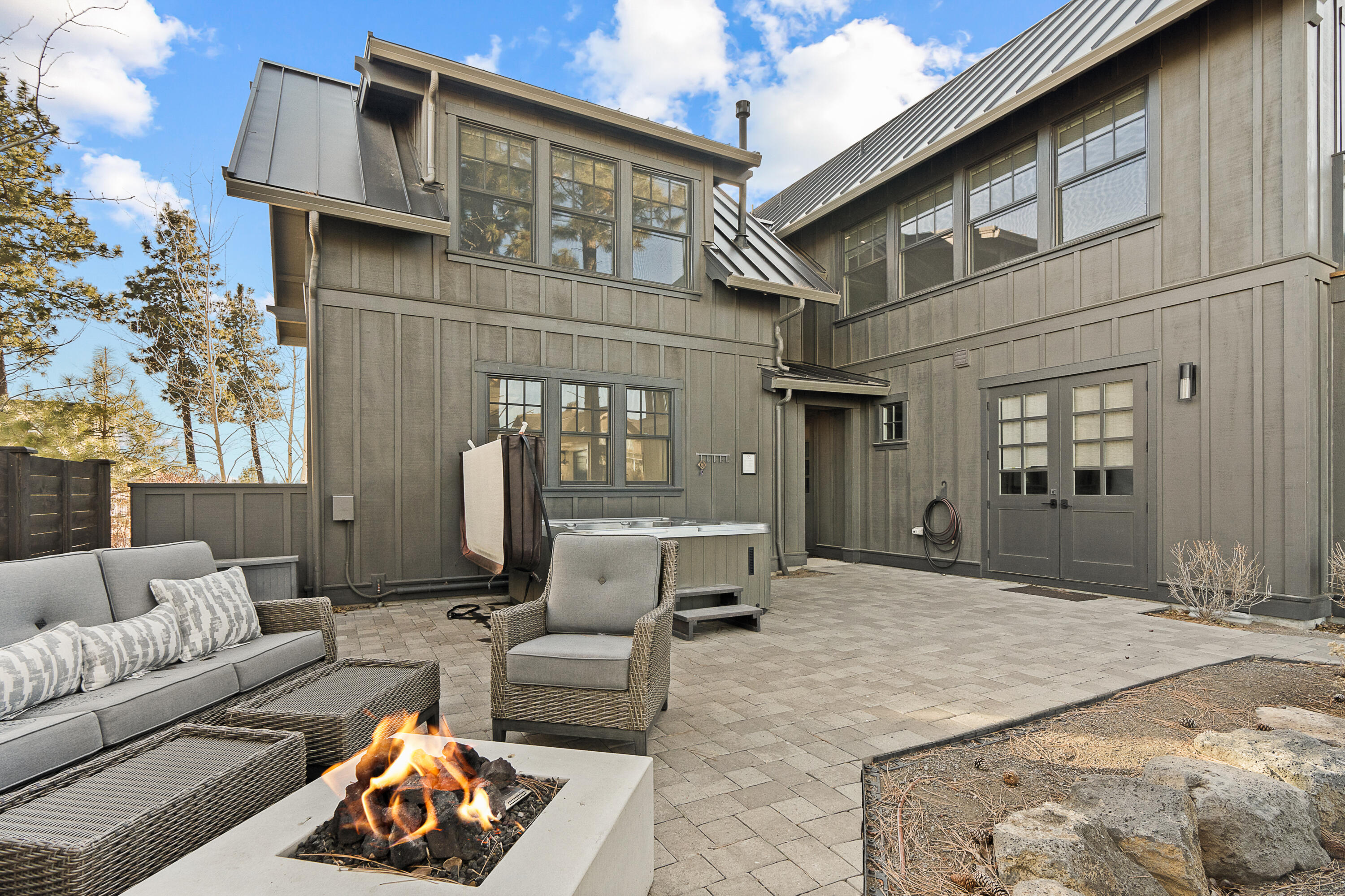 Perfectly blending luxury, convenience, and income potential, this Cairn Vacation Home at Tetherow is the ultimate base camp. Millhouse 5 is a turnkey, fully furnished 2,851 sq. ft. home with 5 bedrooms, a reverse living floor plan, fire pit, hot tub, fine finishes, an EV charger, and mountain views. This rare short-term vacation rental opportunity on Bend's west side is steps from Tetherow's award-winning amenities, including a pool, restaurants, gym, event pavilion, and world-class golf. From biking Phil's Trail to exploring Deschutes National Forest, adventure starts at your doorstep.