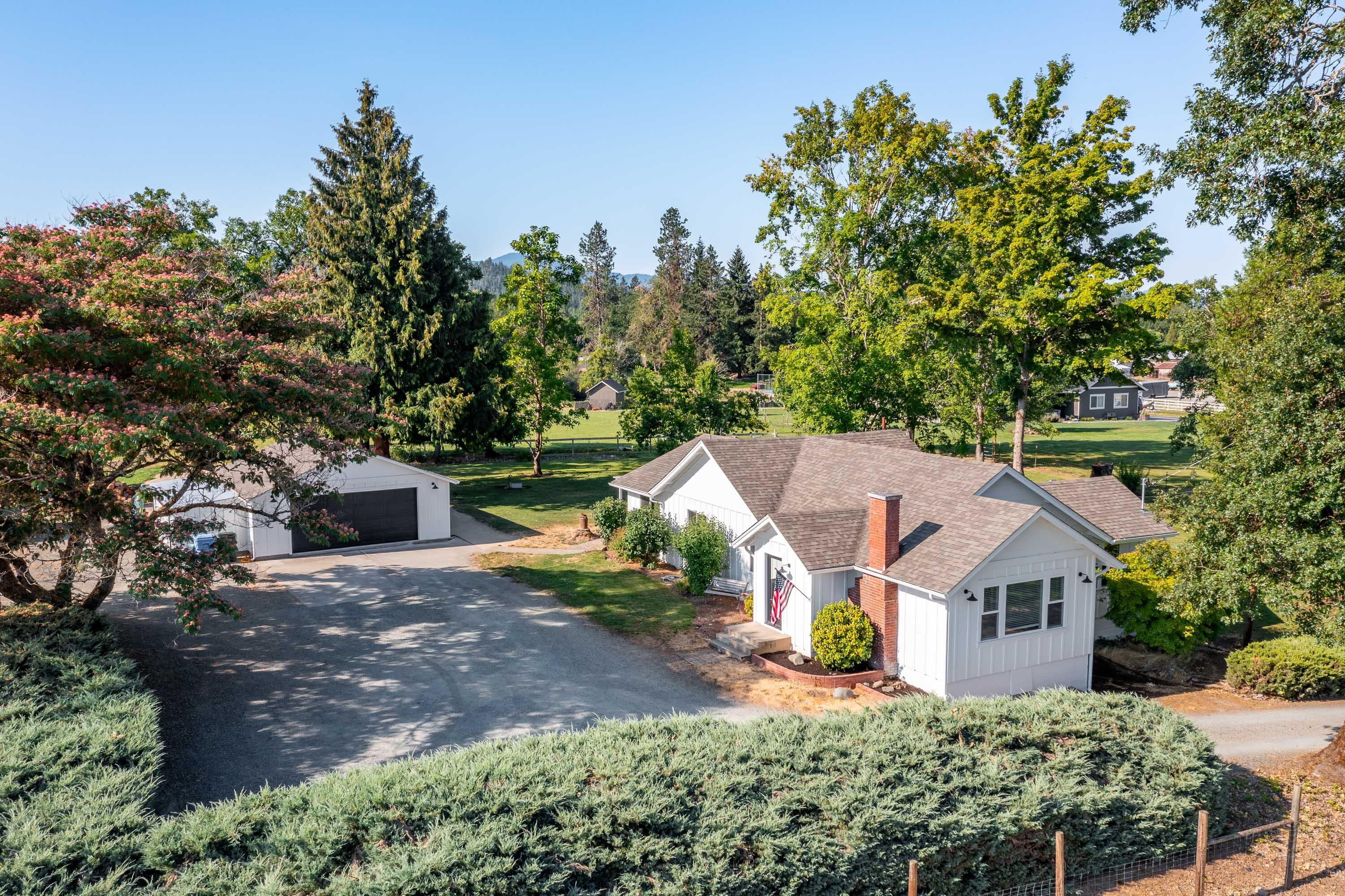 Welcome to 3361 Leonard Road, located in one of the most beautiful & peaceful settings in Grants Pass. The 1649 sq ft ranch style home has been updated/remodeled offering a delightful blend of traditional charm & quality. Home is a 2 bed 2 bath home, with the loft being used as a 3rd bedroom. The 4.63 acres are irrigated, fenced, mostly level and gently sloping, making for a lovely pasture. The park-like backyard offers shade from mature trees, mtn views, perfect for relaxation and gatherings. Detached finished garage is app 648 sq ft, insulated, recessed lights, & mini split for temp control. There is an 864 sq ft unfinished basement for additional storage. New flooring and granite counter tops create a very modern feel and comfort. Living room is very spacious, with brick fireplace. Dining area is large, with lots of natural light and spectacular finishing touches .The blend of home and property checks all the boxes.  All the characteristics of the property and home make it must see
