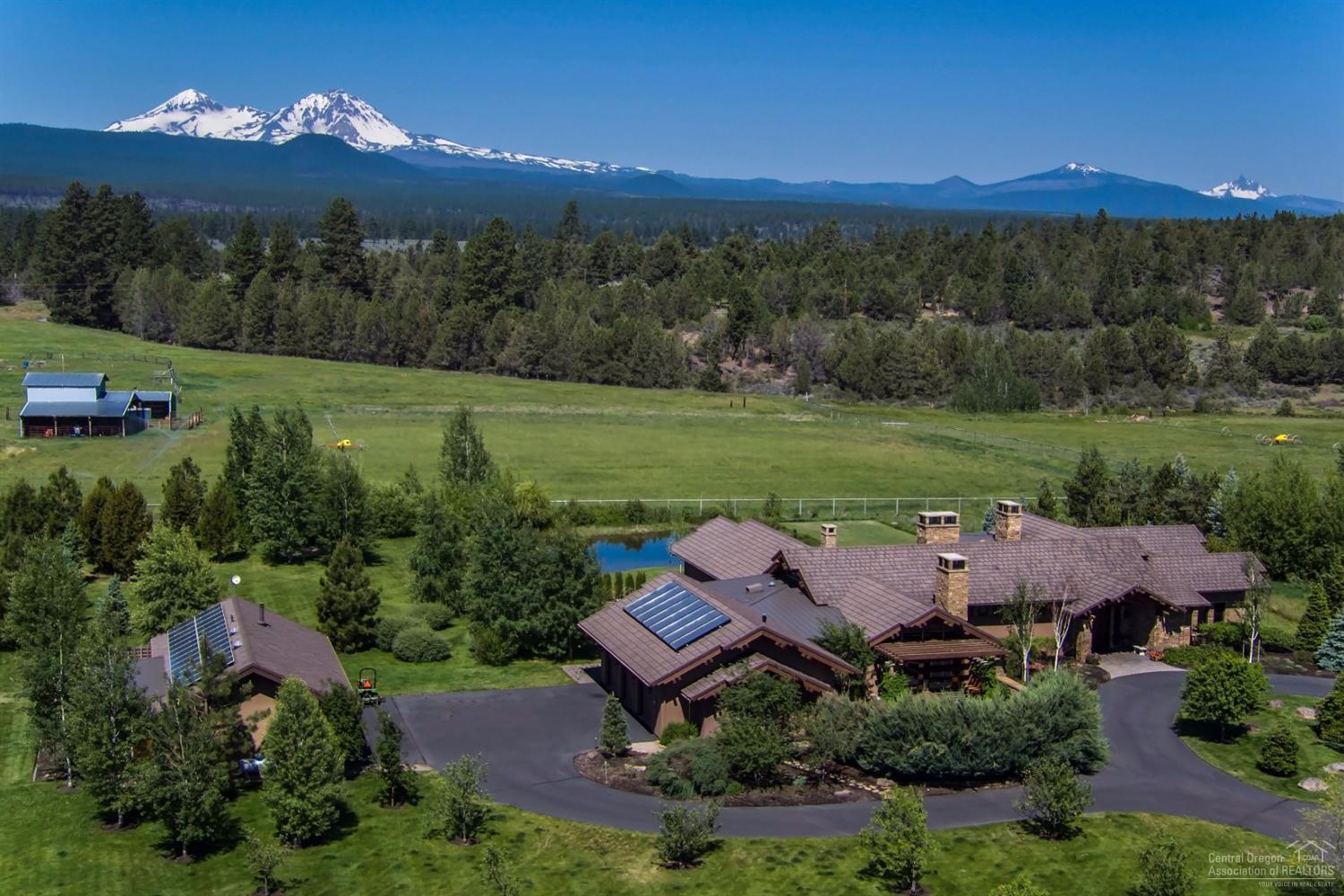 Cascade Mountain Views from the elegant estate situated in the middle of 11 acres in Tumalo. The NW Style Home features: 5614 sf with 4 bedrooms, 4.5 baths, gourmet kitchen, formal dining, living room w/ fireplace, family room, office, hot tub, single level and 5 car garage with office. Wonderful outdoor living with patios, water features, fireplace, outdoor kitchen, garden, greenhouse, orchard, barn and pond. Minutes from the Tumalo Reservoir and National Forest for any recreational lifestyle!