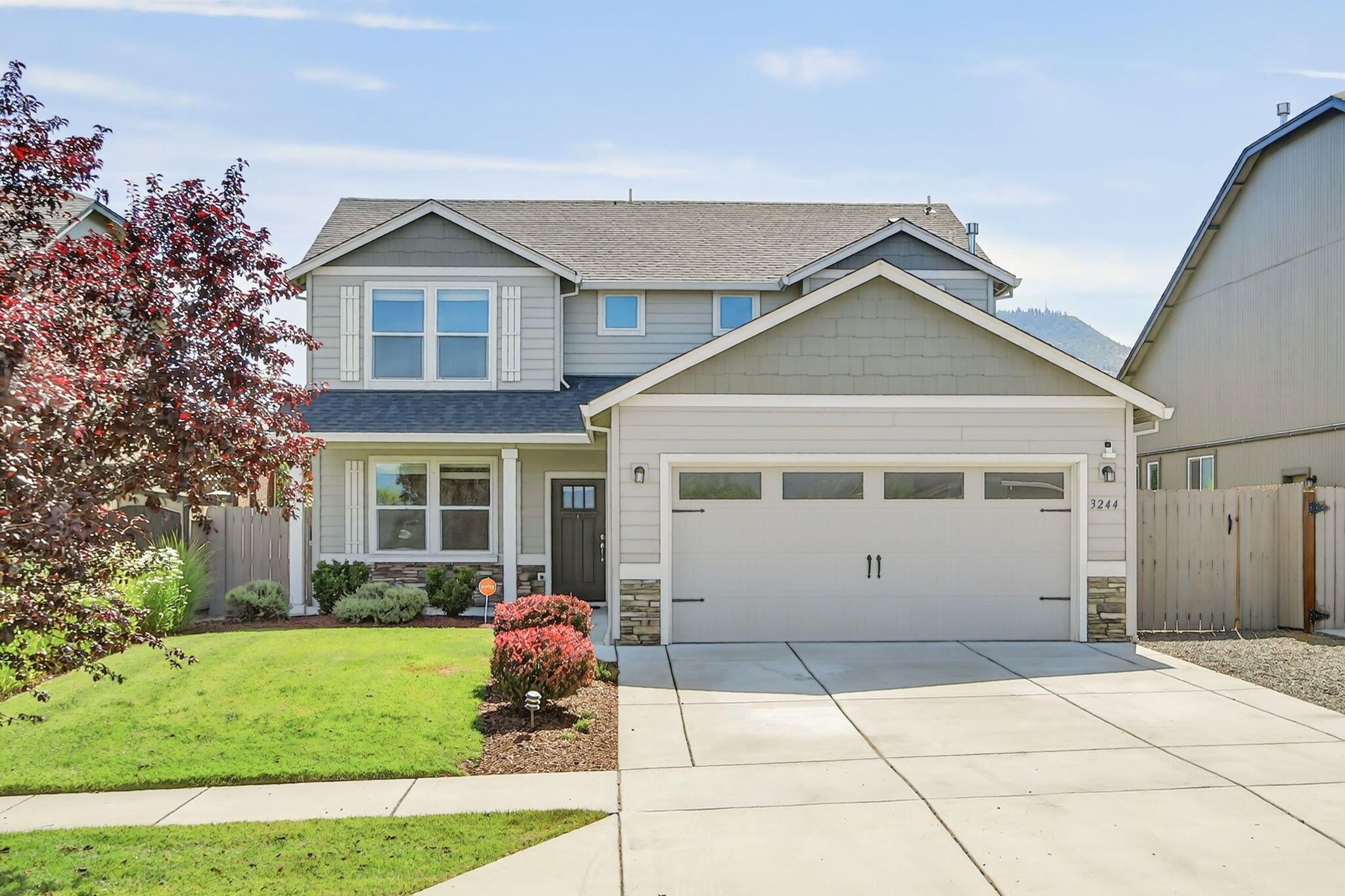Charming two-story home in Northeast Medford filled with great natural light. This 3-bedroom, 2.5-bath property features a main-level office and an open-concept kitchen with a large eat-in island, quartz countertops, tile backsplash and plenty of storage.  The adjacent dining area offers slider access to the covered back patio.  Oversized great room with a cozy gas fireplace. Upstairs is the spacious primary bedroom with soaking tub, dual sinks plus a walk-in closet.  There is also two bedrooms, a full bathroom, and a large laundry room upstairs. The beautifully landscaped back and front yard have inground sprinklers and plenty of yard space perfect for relaxing or entertaining.
