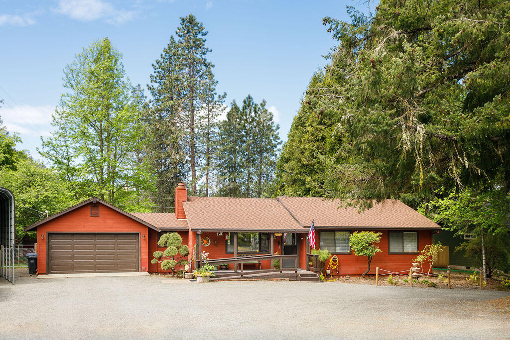 Living the Oregon dream! Park-like setting with private deeded Rogue River access at the end of the cul-de-sac. Or perhaps take a stroll along the wonderful walking path that runs between Weasku Inn and Chinook Park. This country charmer is conveniently located between Rogue River and Grants Pass. Pride in ownership is evident. 3 bedrooms, 2 full baths, family room with windows on 3 sides and 4 large skylights, along with inviting gas fire for those cool Oregon fall and winter days. The living room has a wood burning fireplace to cozy up to. The dining area and kitchen are centrally located between the living and family rooms. Covered RV parking with hook-ups located next to the 2-car garage. Enjoy the completely fenced back yard and the refreshing above ground pool for those hot summer days. A smaller fenced area with raised beds is all ready for your green thumb. This perfect package is just waiting for you to move in and make your own.