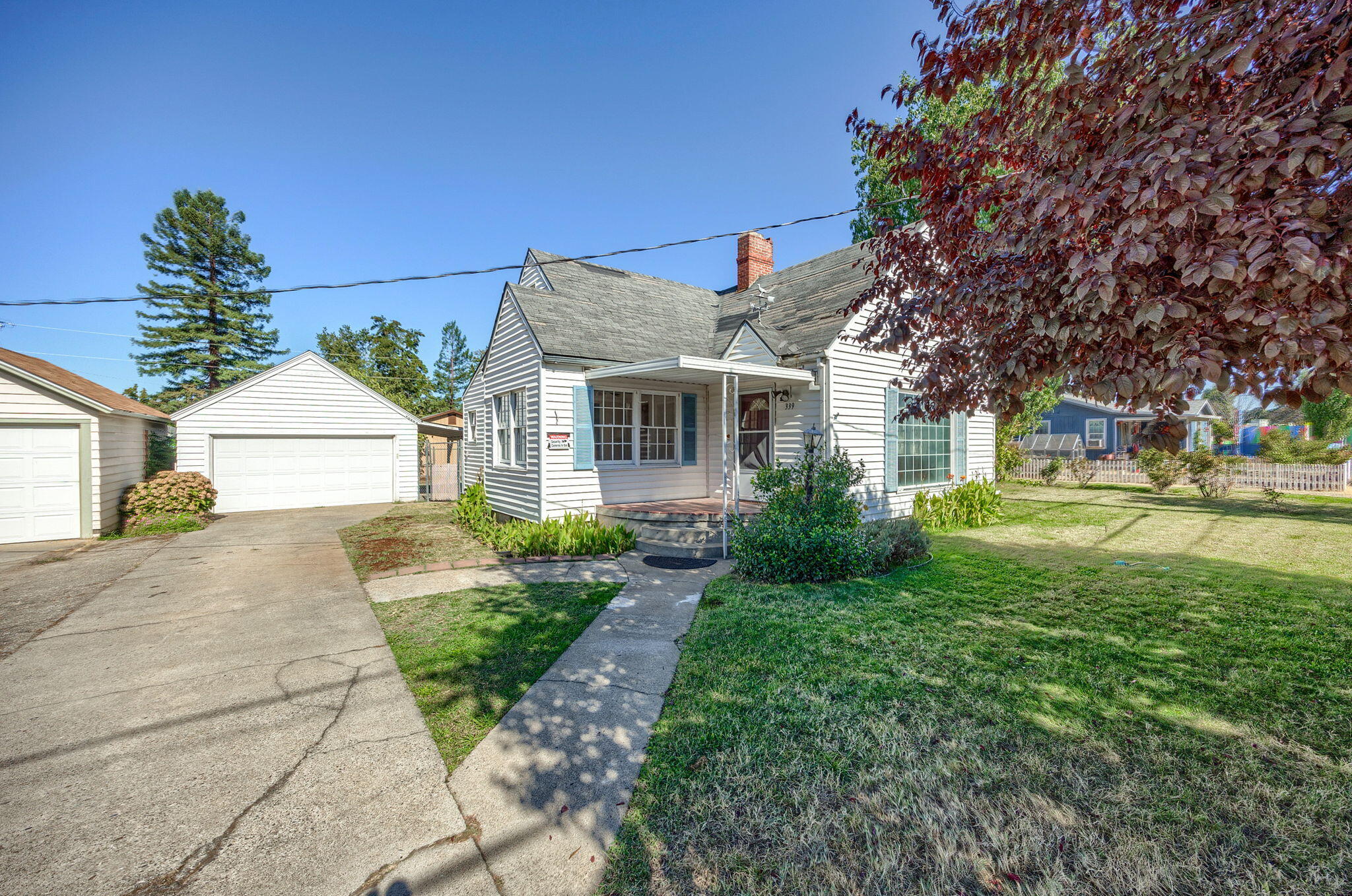 Loaded with possibilities! SFR-10 zoning on .23 acres in the heart of Medford with 1940 built home.  Light & bright w/hardwood floors on the main level including galley kitchen, ductless heat & air in the living room with fireplace, formal dining, main bath features walk-in tub; in-home office and enclosed porch.  Additional 2-dormer style bedrooms and full bath upstairs with lots of built-in storage, newer natural gas forced air heat & ceiling fans throughout. Fully fenced backyard, detached 2-car garage with opener & small covered patio. Per Medford City Planning, potential for lot division, ADU or an additional 3-units. Buyer to do own due diligence including future development potential.