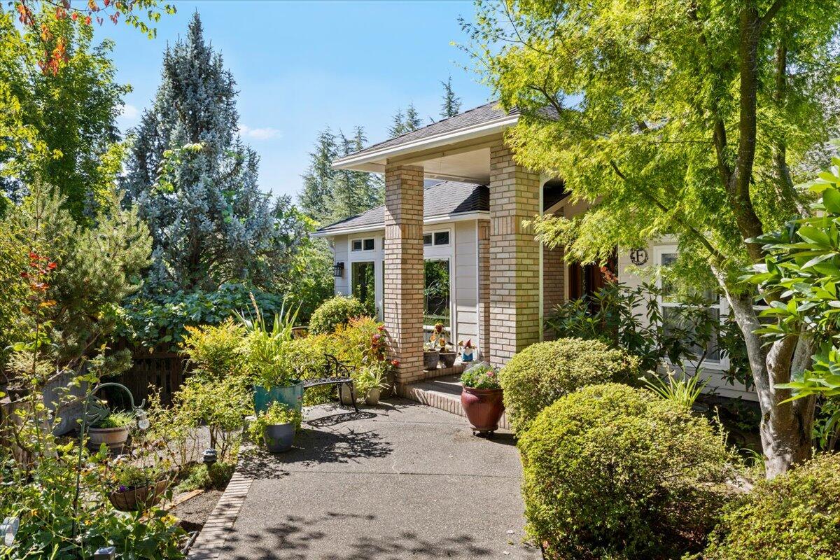 Set on a spacious .28 acre lot, this beautiful home offers a blend of comfort and convenience.  The main living area is one level for easy accessibility.  A bright layout with new windows, vaulted ceilings and views.  The spacious kitchen features granite countertops, double wall ovens, a 5-burner gas cooktop, dishwasher, pantry and heavy duty pull out drawers.  Off the kitchen is a dining room, large living room and family room with a gas fireplace.  Just outside, the covered patio extends your living space outdoors, ideal for entertainment.  The large primary suite has a sitting area, en-suite bath and walk-in closet.  There are two additional bedrooms, a guest bathroom and large laundry room.  Downstairs, a daylight room with full bath and 2 exterior doors that lead to another covered patio with hot tub.  The beautifully landscaped backyard has mature fruit trees and raised garden beds.