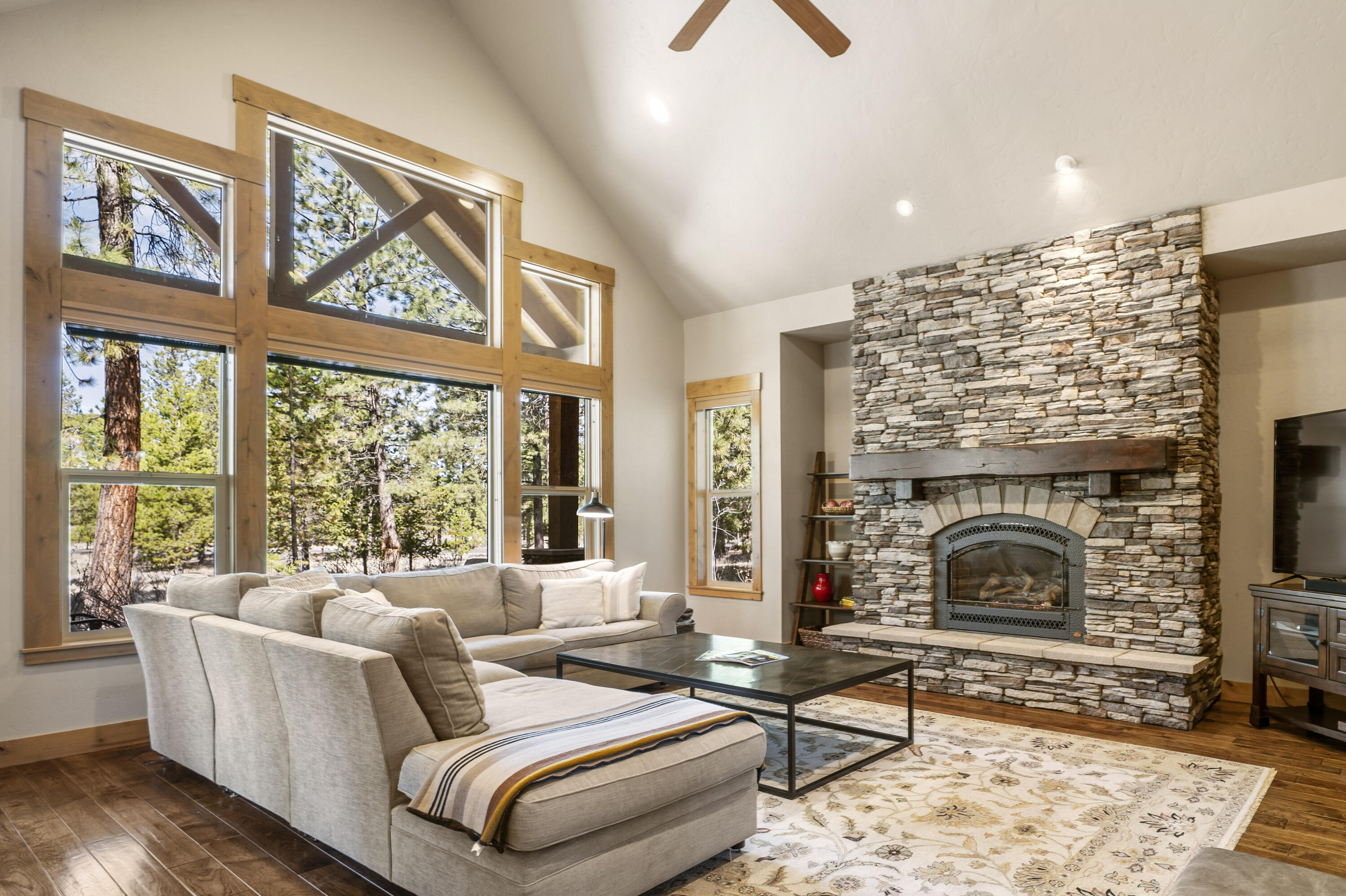 This quality-built home in Caldera Springs offers a prime location w/ easy access to all amenities. The great room features vaulted ceilings, gas fireplace & picturesque views of the surrounding woods. The beautifully designed open kitchen showcases granite counters, breakfast bar & spacious dining area. The main level hosts the primary suite, complete w/ large bathroom featuring a soaking tub, tile shower & large walk-in closet. There is a second guest suite on the main level. Upstairs, you will find 2 additional bedrooms that share a bathroom, along w/ a large bonus room equipped w/ a wet bar, gas fireplace & full bathroom. The private outdoor space includes a covered paver patio & hot tub. Large laundry/mud room leads to a heated, oversized 3 car garage equipped w/ an electric vehicle charger & epoxy floors. Fiber internet installed. Very well cared for & never been rented. 1 year home warranty included! This home is sold furnished & ready to enjoy