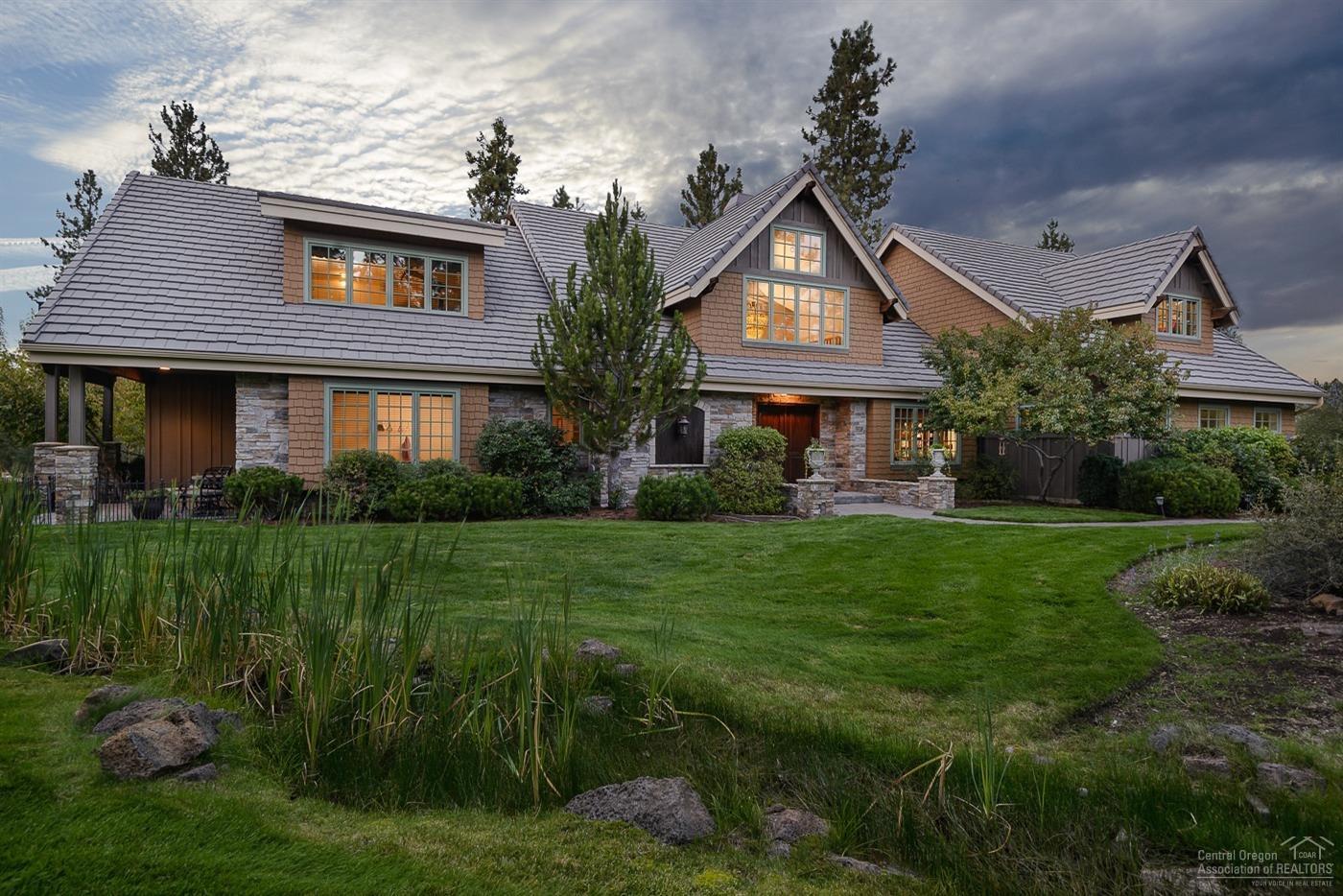 European charm and the High Desert blend seamlessly in this stunning 2.5 acre estate in a gated golf community which borders the Deschutes National Forest. All the quality you would expect and all the fun too! Two Master suites on the main level, bonus room with west facing balcony overlooking pond and Mt Bachelor view, paver walkways and patios, attached 3 car garage and a 1560 sf coach house with shop and half bath! Enjoy wildlife visiting the water feature which boasts a waterfall, stream and pond. Just finished complete remodel of 3 full bathrooms!! Remodel was done by RD Building & Design. Home features two master suites downstairs and two bonus rooms upstairs. Two and a half lush acres plus extra community owned space for the EXCLUSIVE use of the property owner. Concrete tile roof, shake siding with lots of stone accent, Peroda wood entry doors, paver walkways and patio areas to enjoy the wildlife, scenery and views.