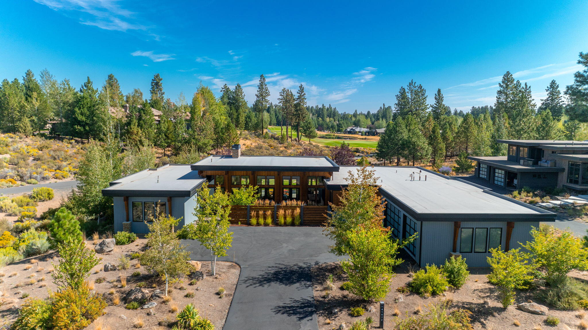 Nestled within Tetherow's prestigious gated community, this one-level residence offers luxury and natural beauty. With stunning views of Mt. Bachelor and the 5th hole of Broken Top Club, the home boasts an open floor plan where natural light floods through expansive windows, seamlessly blending indoor and outdoor living. The great room, anchored by a modern gas fireplace, flows into a gourmet kitchen and dining area, perfect for gatherings. Outdoors, an expansive backyard and an additional gas fireplace provide a serene retreat. Featuring two primary suites, this home offers privacy and comfort.  Designed for those who appreciate both elegance and functionality, this Tetherow gem is a perfect blend of modern living and the serene beauty of the Pacific Northwest. The resort community of Tetherow features 2 swimming pools, fitness classes, restaurants, golf & more.