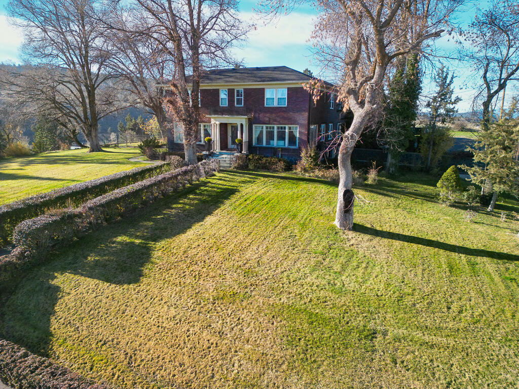 Discover one of Klamath Falls' most distinctive historic homes. Built in 1926 and set on nearly an acre, this remarkable 8,500+ sq ft estate blends timeless architecture with impressive scale and versatility. Multiple gathering rooms, generous bedrooms, period details, and abundant natural light create a comfortable yet elegant living experience suited for both everyday life and large-scale entertaining. Unique amenities include a brick-and-glass greenhouse, outdoor saltwater pool, spa, sauna, four-car garage, and additional covered parking. Separate living areas offer outstanding flexibility for multi-generational living, guest quarters, or private office use. The expansive lot provides space to garden, expand, or simply enjoy rare in-town privacy. Close to downtown, parks, and local services, this landmark residence offers convenience, history, and exceptional potential—an iconic Klamath Falls property ready for its next chapter.
