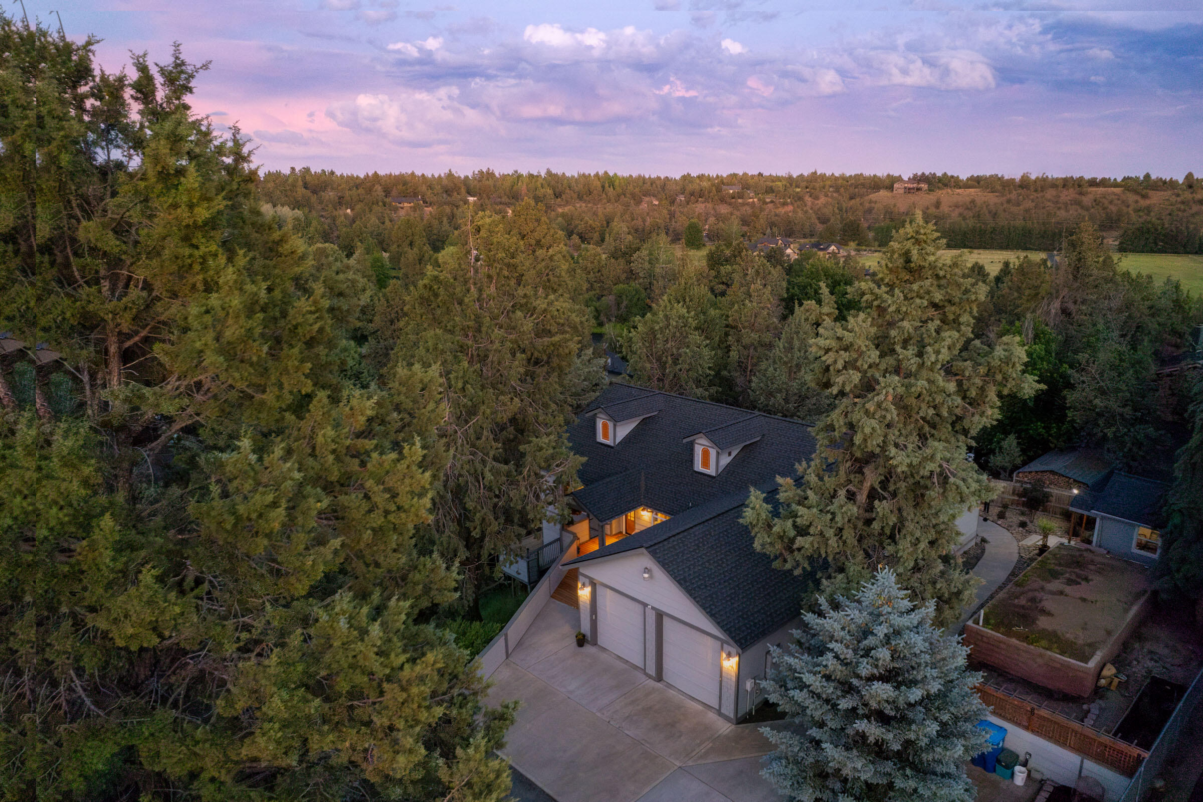 This truly one of a kind Tumalo property is a must-see! It has an enormous amount of living space. The main level has an open floor plan that is perfect for entertaining, theres an  induction stovetop & soapstone island that seamlessly blends the dining & living room, then flows out onto the deck. MAIN FLOOR; primary suite, also two additional bedrooms, & a full hall bath. Downstairs offers nearly 2,000 sq ft of finished space with a private entrance, kitchenette/bar, full bath, mud/utility room, & a flexible area for an office, gym, or guest suite, ideal for multi-generational living or rental potential. Multiple outdoor spaces, terraced landscaping, a gorgeous sunny deck, & a private hot tub. A 12' x 16' outbuilding for a garden shed, studio, or office. There's an RV 30amp hookup. With abundant storage & thoughtful design, this home is as functional as it is charming. Take a stroll to the private neighborhood access to the river trial & just around the corner from The Bite in Tumalo