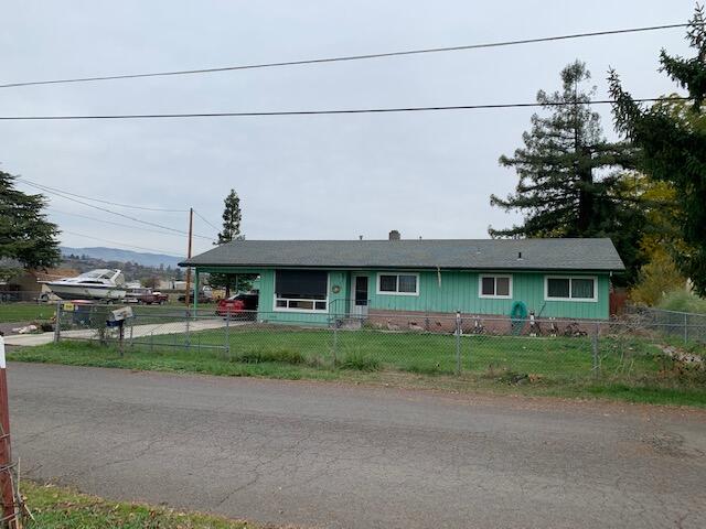 Shop Enthusiasts! Not one shop but two on .77 of an acre! The larger shop (approximately 30 X 40, per seller) has heat and a room that could be an office or hobby room has a bathroom complete with a shower.  Smaller shop (approx..600- 700 SF, per seller) has a storage area with shelving, heated and large doors that roll side to side.  Both shops have 220.  Home has 3 bedrooms, 2 baths (one with tub the other has shower), galley kitchen with a dining area, laminate flooring, large living area, washer and dryer, car port, covered patio, 2 wells, one for house use with a newer pump and the other well for irrigation.  This property has an RV Dump and RV Hook Ups. Also, there is plenty of room to park all your recreational vehicles.  This property has great possibilities.  Buyer to do their own due diligence.  Call for your personal tour!