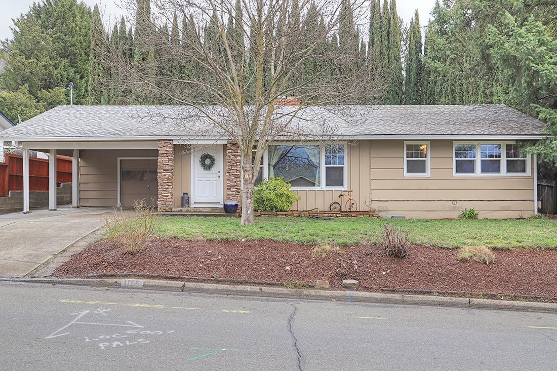Located just across the street from Lincoln Elementary sits this quaint Northeast Grants Pass charmer, with hardwood floors that welcome you into a light and bright interior, showcased by the large picture windows, many of which have been recently updated. The open floor plan maximizes the feel of this 1,040 sq/ft 3 bedroom, 1 bathroom home. The bedrooms are newly carpeted, one of which has French doors that open up to the living room and could be easily used as an office or separate sitting room.The spacious kitchen provides room to prepare the meals you'll enjoy on the covered back patio, complete with a built-in barbecue. The spacious back yard is completely enclosed by evergreens that offer privacy and a feeling of seclusion for this city lot. Priced perfectly for the first-time home buyer, this home would be the ideal spot for a young family or someone looking for an affordable home in a great neighborhood. Come check it out!!