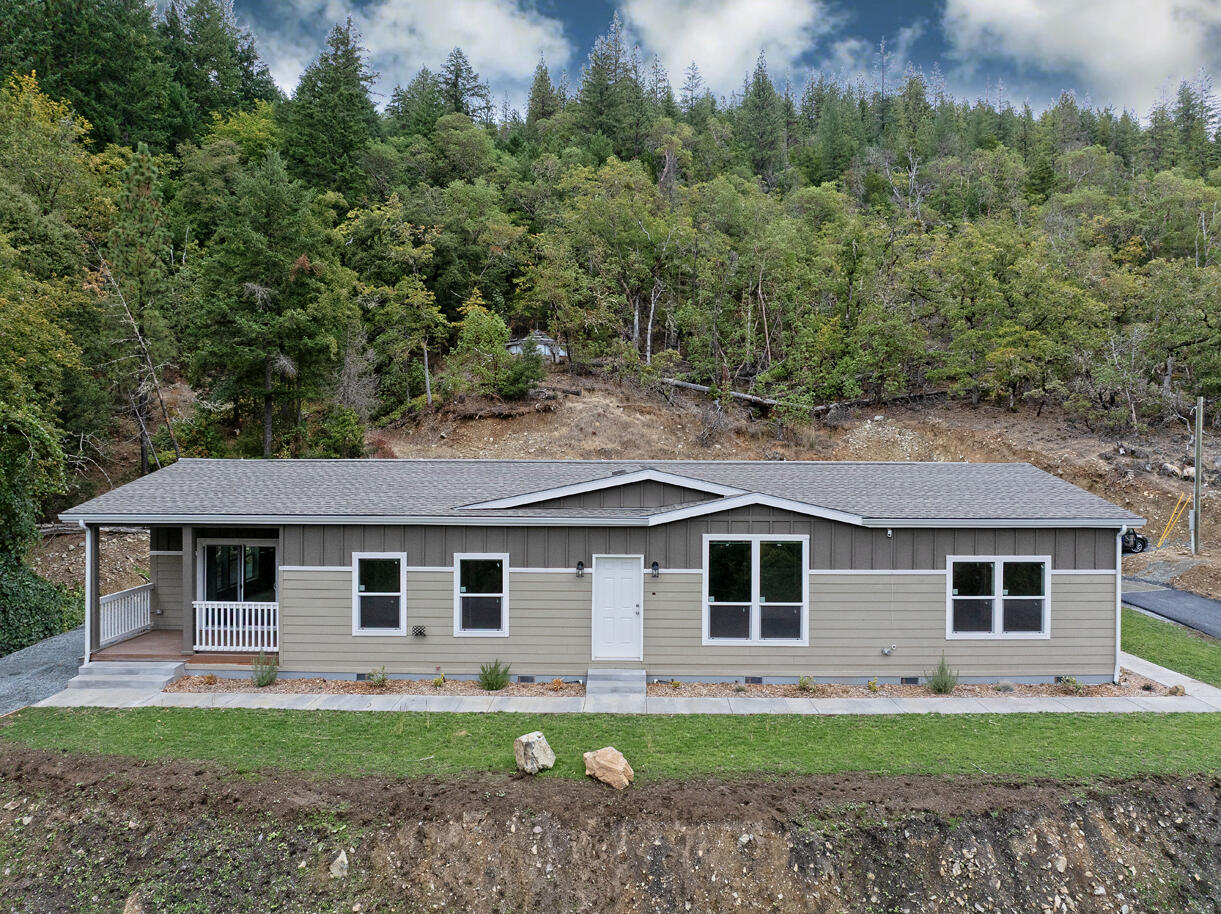 Enjoy the best of country living in this brand-new 3-bedroom, 2-bath home, perfectly set on 4.55 peaceful acres. Offering 2,023 sq ft of thoughtfully designed space, this home features a bright, open floor plan with high-quality finishes and plenty of natural light. The kitchen boasts modern countertops, stainless appliances, and a spacious island that flows seamlessly into the living and dining areas. The versatile den is ideal for an office, guest room, or hobby space, while the mudroom adds everyday convenience. Outside, you'll love the fresh landscaping, newly asphalted driveway, and open acreage—ready for a garden, shop, or animals. Move-in ready and just minutes from town, this property combines comfort, style, and wide-open living. Spectrum cable has been installed.