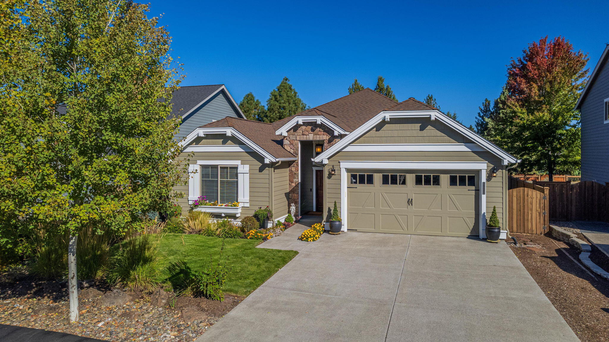 Welcome to this rare single-level home backing to the canal in the sought-after Pahlisch community of The Bridges in SE Bend. This light-filled home features 3 well-separated bedrooms, including a spacious primary suite and a junior suite. Enjoy high vaulted ceilings, oversized windows, skylights, knotty alder cabinets, and granite counters throughout. The primary bath includes a large walk-in tiled shower, soaking tub, and walk-in closet. Built in features on both sides of the gas fireplace in the great room. Step onto the covered back deck from the dining room or the primary suite to a beautifully landscaped, fully fenced yard. The canal's elevation change creates a relaxing sound and draws in local wildlife. Extra storage in the garage & outside sheds. The Bridges offers trails, playground, pool & hot tub, clubhouse, fitness facility, game room, and full basketball court. The NEW Alpenglow Park and Caldera High are nearby!