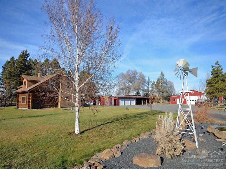 Wonderful 2-story log home in a picturesque private setting on canal waterfront. Located between Bend/Redmond on 11.44 acres with 9.4 acres of irrigation. Fenced and cross-fenced and surrounded by lush green pastures. Cozy open space living with kitchen remodel. French doors and upstairs balcony open out to inviting outdoor area. Many outbuildings include a huge shop, barn, 3-car garage/shop combo, covered equipment storage, greenhouse, smokehouse, log dog house & chicken coop. Country living at its best!