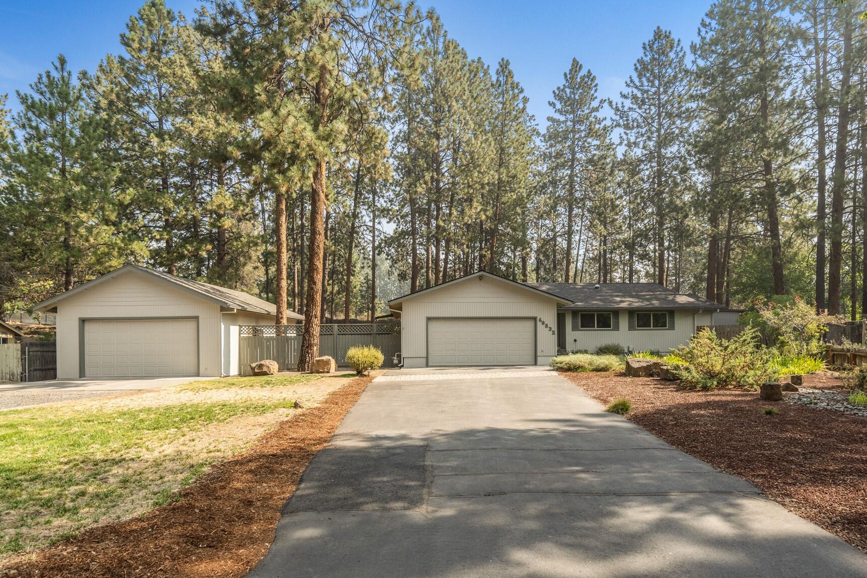 Turn-key home in SW Bend nestled on a half acre w/ easy access to HW 97, just min to River Rim Park, Deschutes River & Old Mill. Vaulted great room ftrs recently t&g wood ceiling, wood burning fireplace insert w/stone surround & a skylight brings in an abundance of natural light. Kitchen offers w/laminate flooring, granite ctrs, tile backsplash, gas range, SS appliances, tons of cabinet & prep space, eating area w/ sliding glass doors to patio. Oversized primary bedroom is carpeted w/vaulted primary bath featuring skylight, step in shower, dual vanities, walk in closet w/ built-ins, plus door leading to the patio. 2 addtnl bedrooms share full bath w/ shower/tub combo. Attached double car garage ftrs workbench & shelving. Additional detached garage/shop is 36x24, fully insulated w/ built-in cabinets & shelving, carpeted office w/ window, secured room, wood burning stove, plug for electric vehicle & garage door opener. RV parking plus 5 station irrigation system, chicken coop & storage.