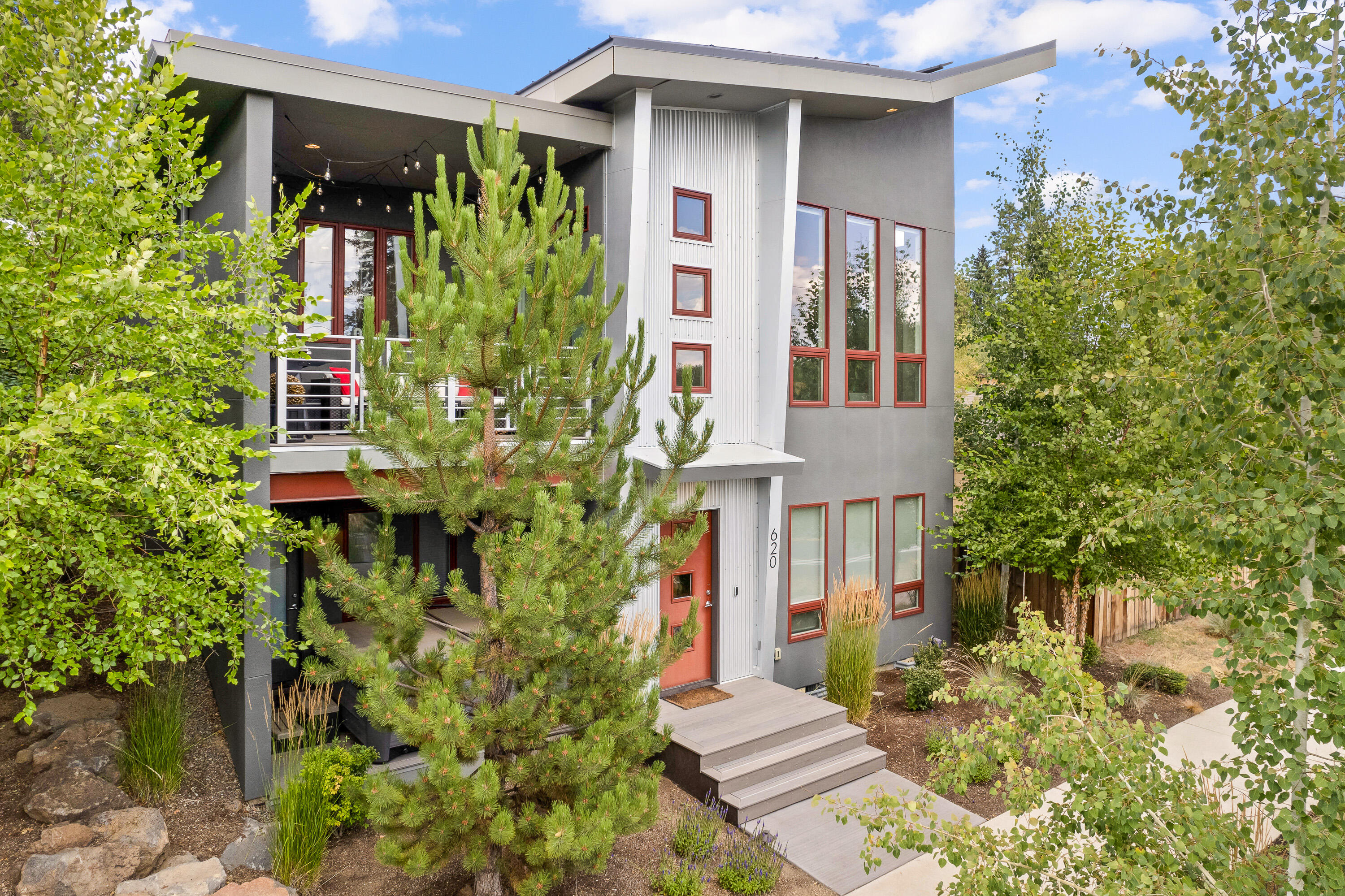Welcome to this contemporary home situated in the Westside corridor in the heart of Bend. This masterpiece of design and craftsmanship embodies a perfect blend of concrete, wood, and steel, exhibiting a unique modern industrial aesthetic. Primely located, this home boasts unparalleled convenience to outdoor recreation, minutes away from trails, rivers, and mountains. For those who enjoy the city's allure, the home is central to Bend's dining scene and shopping destinations. It uniquely unites the appeal of city living and the tranquility of nature. Revel in the opulence of the main level primary suite, brimming with natural light and showcasing a finely designed bathroom. The open floor plan exudes a warm, inviting ambiance, perfect for entertaining or relaxing. The state-of-the-art kitchen is furnished with high-end appliances and sleek countertops, set against a backdrop of modern design elements. Experience a touch of luxury and convenience in this remarkable Westside home.