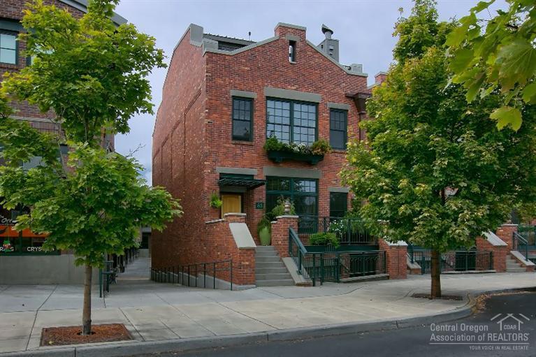 Sophisticated interior accents & midcentury furnishings complement the design elements of this Mill Quarter Townhome. Located in the heart of Bend between Downtown & the Old Mill District. The exteriors were inspired by East Coast Brownstones. The modern interior reflects an industrial architectural design w/dramatic ceilings, exposed ductwork, gourmet kitchen w/Commercial Viking appliances, cork & concrete floors, wool carpet, private elevator, and expansive private rooftop deck. And no HOA fees!