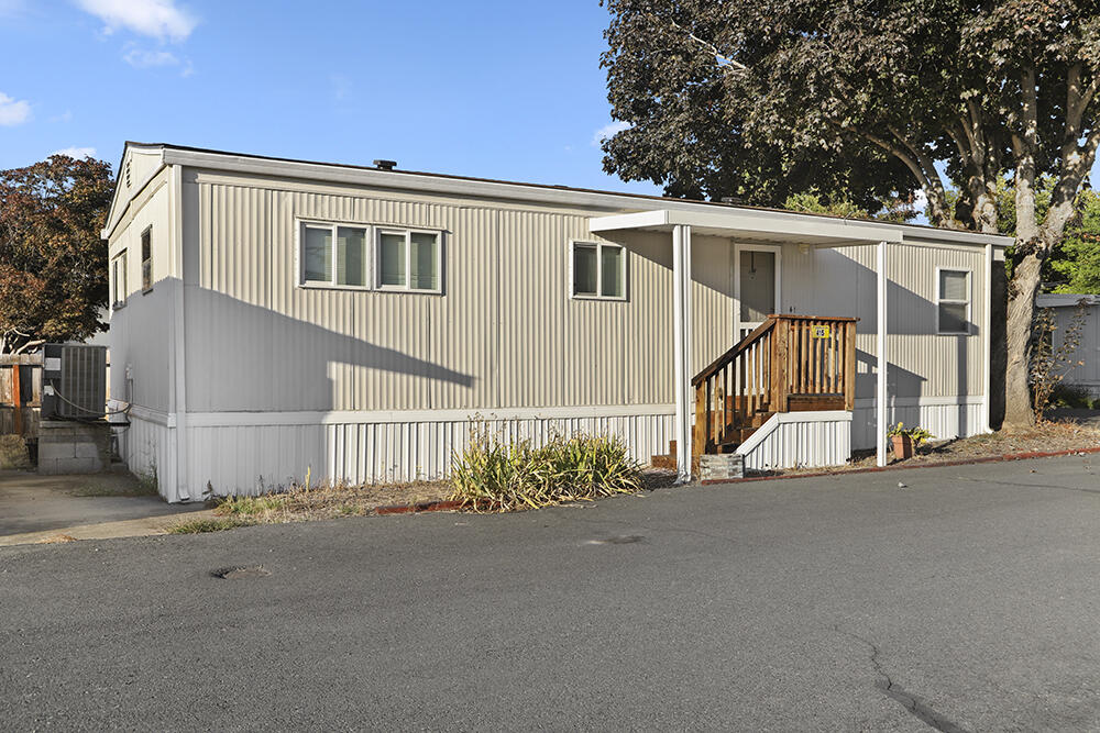 This cute double-wide is located at the end of the street on a corner lot and conveniently near the riverfront park!  The home is 800 sq ft with two bedrooms, one bathroom, and an extra room for your crafts, storage, or pet!  Relax in your home with a comfortable floor plan including a roomy living room and galley kitchen, or take a stroll down to the beautiful Rogue River right there in the park!  This is a quiet 55+ park with a nice, country feel yet close to town.  Don't let this one get away!  Schedule your showing today!