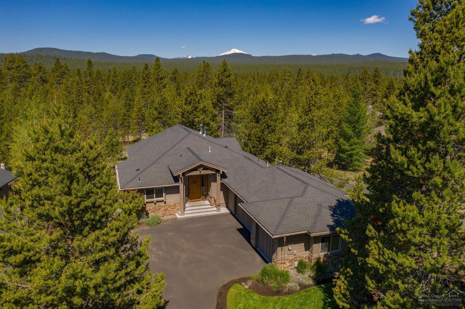 Get away or get together at this inviting mountain retreat. Nestled on a large treed lot, this gorgeous home maximizes the setting with a well-thought-out floor plan offering fantastic separation of space. Featuring a designer furniture package, 6-bedrooms--all suites, 6-full baths, powder bath, spacious great room, large gourmet kitchen with breakfast bar, additional family room and kitchen downstairs, laundry room with 2-washers/dryers, and oversized 3-car garage--this is your basecamp for adventure! Abundant windows throughout bring the outside in and create a warm and welcoming place for family and friends to gather. Elegant stacked stone gas fireplace, gleaming hardwood floors, vaulted ceilings, wood wrapped windows and extensive stone and tilework add rustic charm. Take in the Central Oregon sunshine on the expansive decks backing to common space. Soak under the stars after a day of adventure in the private hot tub. Create your Sunriver legacy!