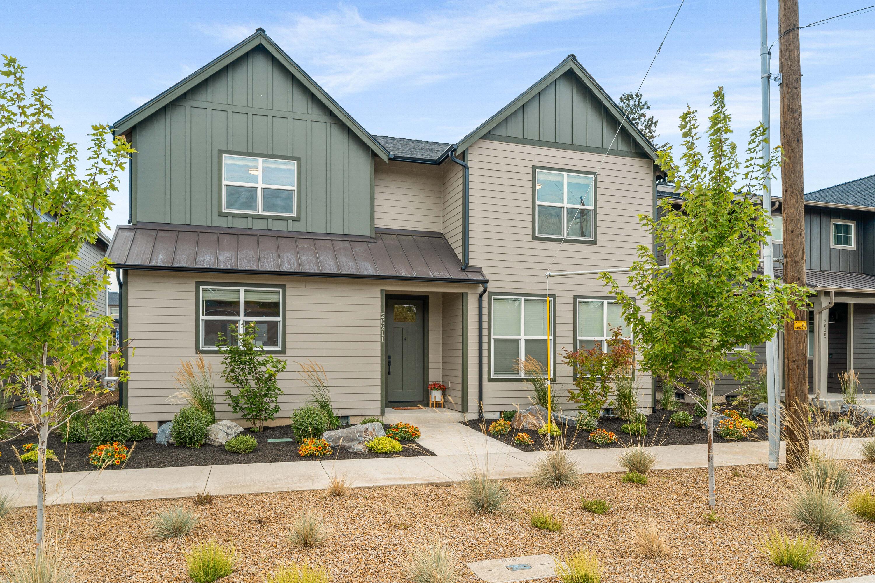 Experience the Bend lifestyle in this better-than-new 4 bed, 4 bath home offering nearly 3,000 sq ft of refined living space. Upgraded, High-end hardwood floors sweep throughout the entirety of the home, while a natural gas fireplace with tile surround and gorgeous mantel in the dining area adds warmth and charm. The gourmet kitchen boasts modern finishes,, large pantry, SS appliances, sleek cabinetry, and ample space for entertaining. The flexible floor plan includes a main-level suite ideal for guests or multi-generational living, while the upstairs primary retreat provides a peaceful escape with a spa-like ensuite. Step outside to a private, landscaped backyard with a covered patio—perfect for year-round gatherings. A 2-car garage adds everyday convenience, and the prime location puts you minutes from breweries, Costco, trails, and all of Bend's best dining, shopping, and outdoor recreation.