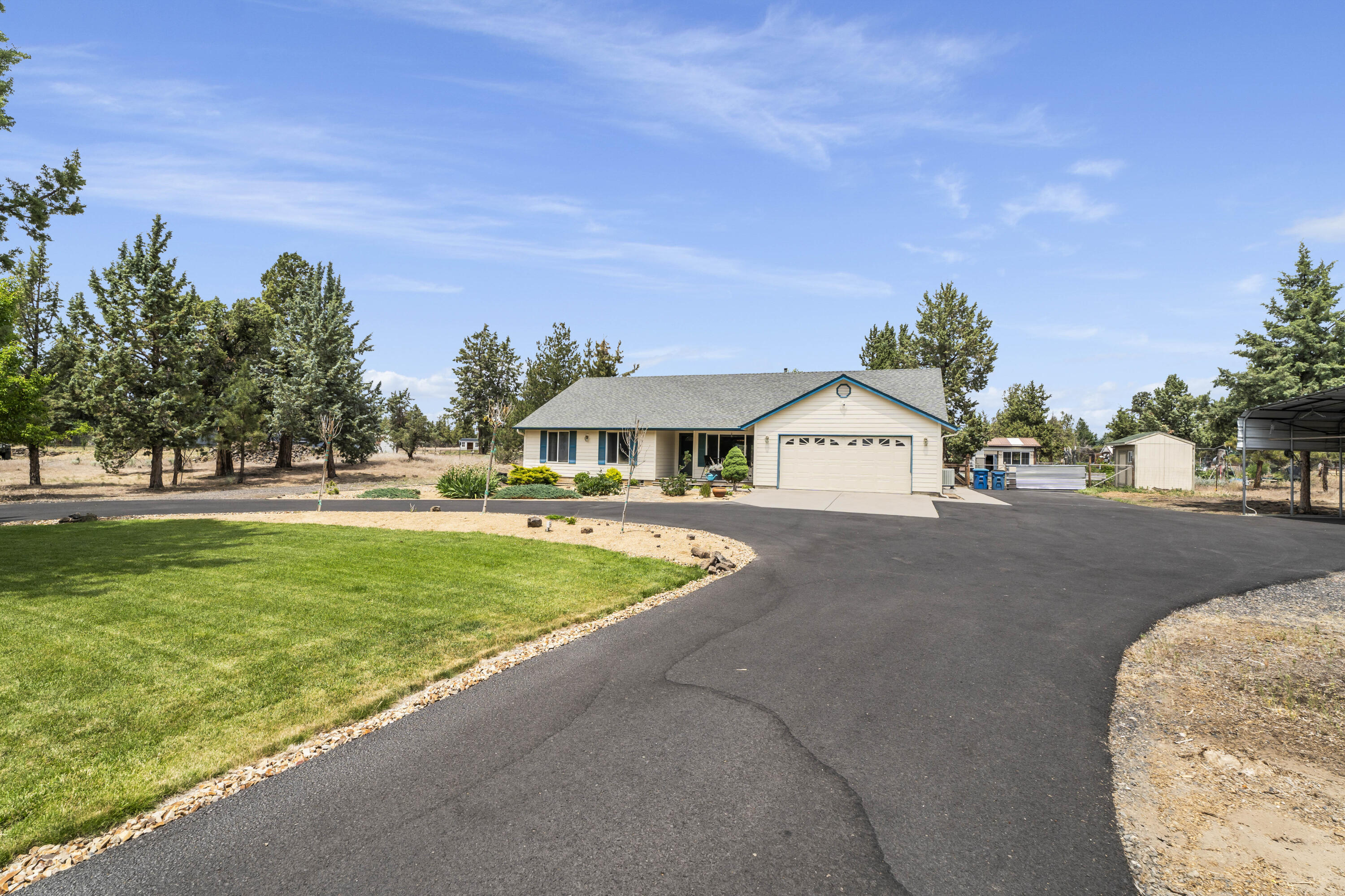 Beautifully maintained 2.3-acre property offering comfort, space, and versatility — with potential to build an ADU! The 1,823 ± sq ft home features 3 bedrooms, 2 baths, vaulted ceilings, and a newer pellet stove for cozy evenings. Enjoy an updated kitchen with a KitchenAid downdraft stove and Fisher & Paykel two-drawer dishwasher. Outside, you'll find a well-kept barn perfect for storage, hobbies, or animals, plus fenced garden areas, greenhouse, and ample RV/toy parking. Additional highlights include a heat pump with cooling, new bedroom carpet, and hookups ready for your hot tub. New roof and skylight installed August 2025. Shown by appointment only.