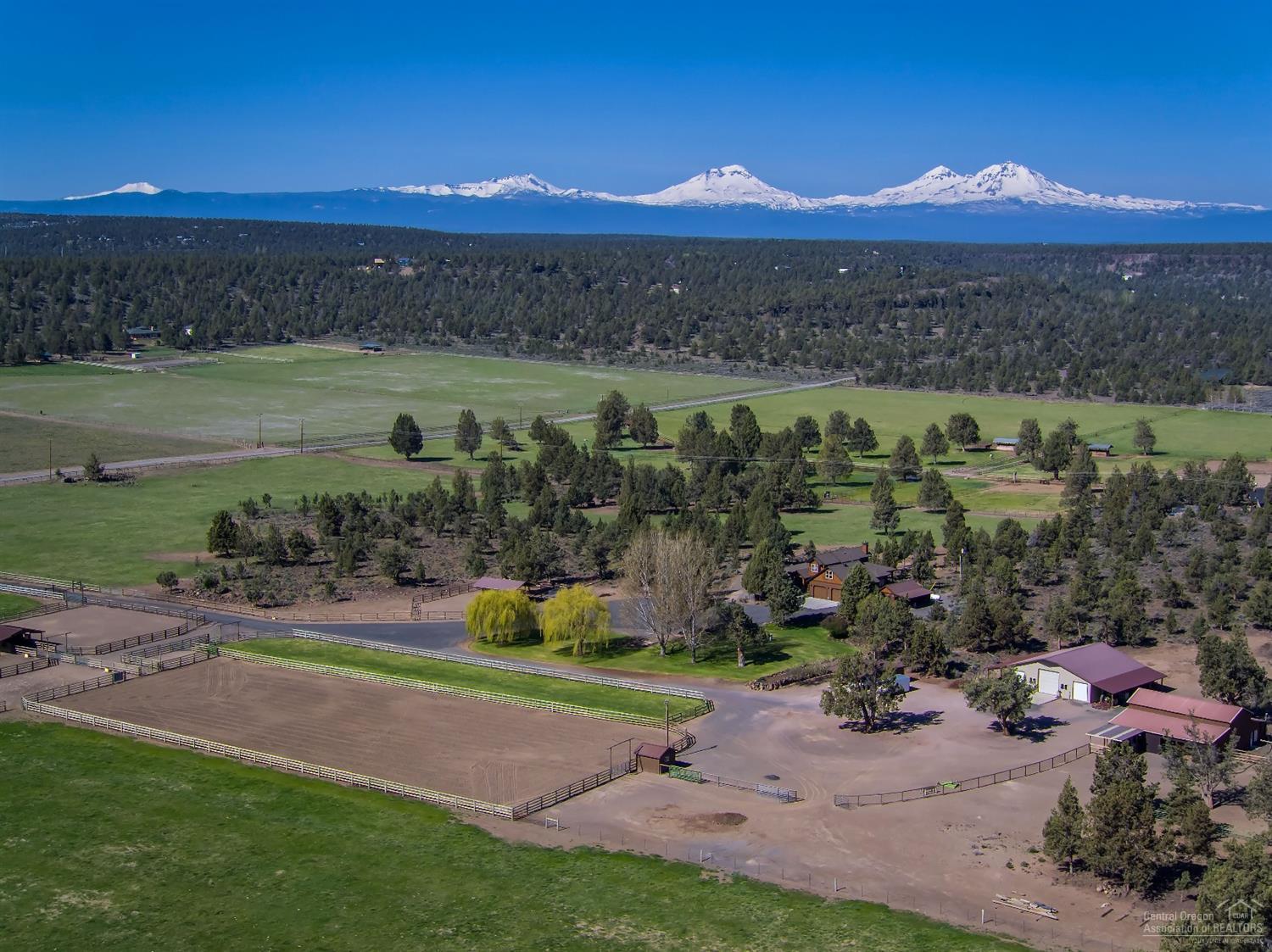 Country Home in Odin Falls Valley on 37 acres with 18 acres of well water rights. Custom Home is 2985 sf, 3 bedroom, 2.5 bathroom, kitchen with SS appliances, living room with fireplace, office, master suite on main, wood & tile floors, bonus room. Property includes: outdoor arena, covered livestock shelter, storage building, 48x52 shop/RV storage, Barn with office, runs, tack room, property borders public land and fenced with pole/no climb. Private Setting with Cascade Mountain Views.