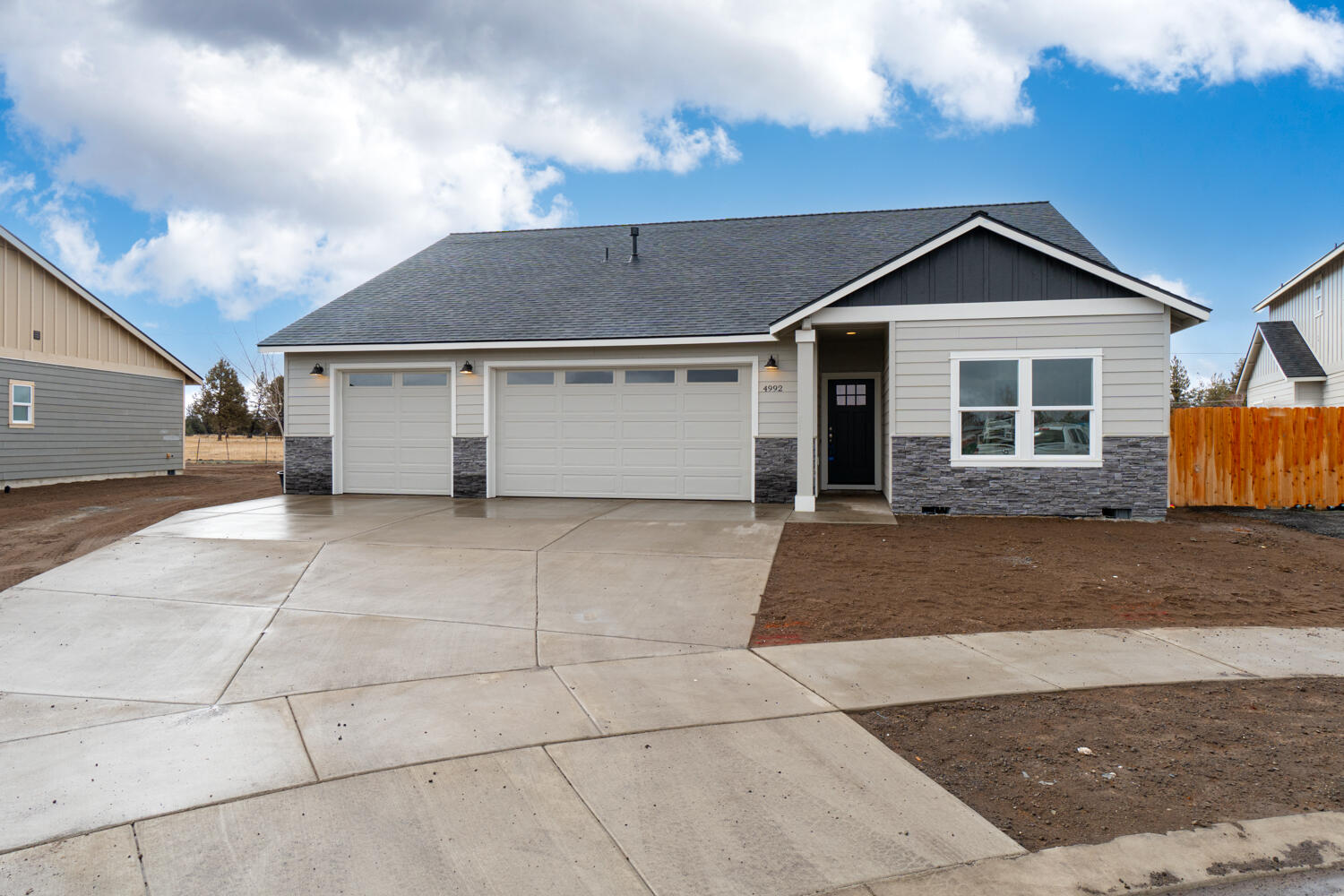 Affordable luxury built by Dunlap Fine Homes on the Bend side of Redmond w/Cascade Mtn Views. Spacious living both inside & out, w/plenty of room for entertaining. Vaulted Great Room plan w/open Kitchen, tons of cabinetry & prep space on the slab Quartz counters and breakfast bar. Neat & tidy full height tiled back splash, SS appliances & farm sink. Living space offers a cozy corner Gas burning fireplace w/stylish accents & room for gathering. Desirable primary bedroom separation, walk in closet, step in shower, tiled floors & dual vanities. 2 additional guest rooms w/full bath. Laundry room w/storage & sink. Durable wood look laminate flooring, carpet in the bedrooms/closets & tiled baths. Gas forced air, A/C & back patio. Triple car garage, gated RV parking, fully fenced, fully landscaped w/auto sprinklers. Come tour it today or visit our open house! Open Saturdays & Sundays 12pm-3pm.