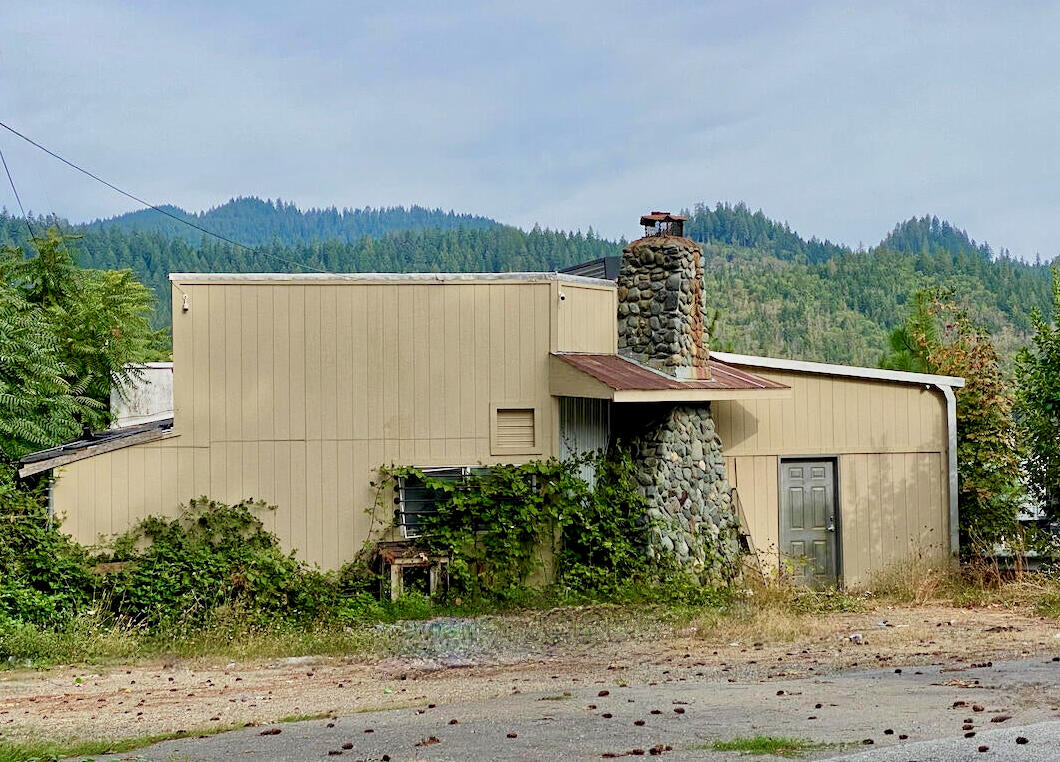 Freeway exposure offers great opportunity with this Rural Commercial property in Josephine County! Ideal location for gas station with access from North and Southbound traffic at the freeway on-ramp across from Sunny Valley RV Park. The main building was formerly used as a restaurant, night club, and dispensary. Gas station permitted per County! Small out-building with a kitchen and bathroom next to the main building which could be a studio apartment. Estate sale, sold as-is. Personal representative can not make repairs or improvements and makes no warranties regarding size, uses or condition of buildings or equipment. All information is deemed accurate, buyer to verify to their own satisfaction.