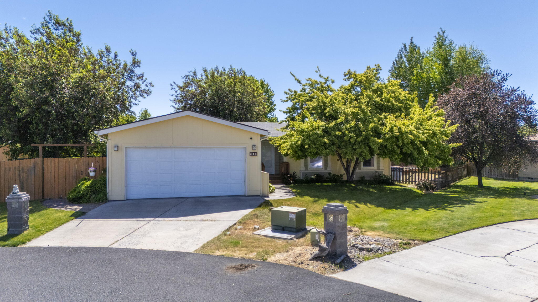 Welcome to your new home located in a peaceful cul-de-sac! This lovely home features mature shade trees and a large, fenced backyard with low-maintenance landscaping, concrete patio and multiple raised garden beds and a drip irrigation system-ideal for relaxation and gardening. Inside, vaulted ceilings and abundant natural light create an airy, open atmosphere with attractive laminate flooring throughout the main living area. The spacious kitchen is a chef's dream, complete with a generous cabinet package, a new refrigerator and microwave. Attached 2 car garage for convenience also provides direct rear yard access. Recent updates include a new furnace, heat pump, and water heater, ensuring year-round comfort and peace of mind. These enhancements make the home efficient and reliable. Close proximity to schools, parks, shopping and hospital!
