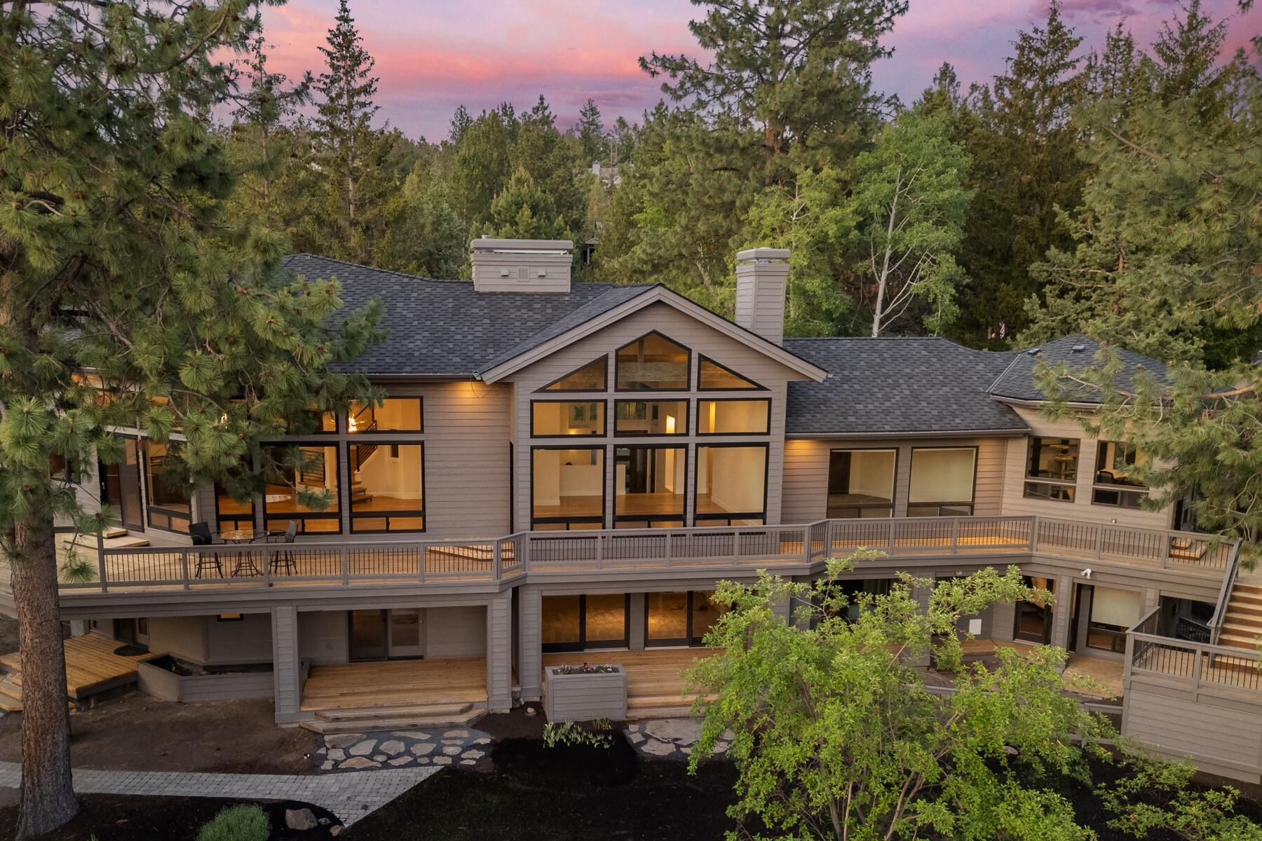 Incredible value and quality on the Butte. Enjoy breathtaking views of Mt. Bachelor, Broken Top, and the Three Sisters from this exquisitely renovated .77-acre retreat. A 2024 transformation elevates sophistication with a new roof, all-new windows and doors, and a chef's kitchen with Thermador and JennAir appliances, a 10-foot island with prep sink, walk-through pantry, and functional mudroom. The main level features vaulted living and dining areas with a double-sided fireplace, a vaulted primary suite with spa-like bath and laundry, and two flexible offices. Expansive decks capture sweeping Cascade views and a serene backyard designed for entertaining. The lower level includes a private guest suite with separate entrance, kitchenette, laundry, a den with fireplace, and Jack-and-Jill bedrooms. Additional highlights include a wine room, elevator, hardwood floors, new carpet, flat driveway, 3-car garage, and ample storage, all minutes from schools, trails, and Bend's westside amenities