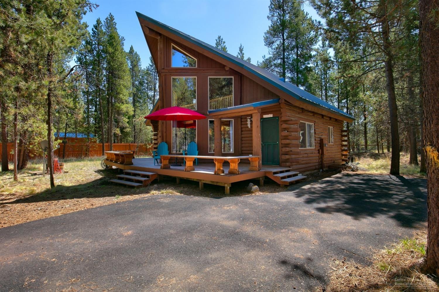 Charming Rustic Cabin minutes from OWW boat launch and river access! Vaulted great room w/ walls of windows. Outstanding solar orientation & privacy on this treed lot! Distressed pine floors, free standing wood stove, large master suite, and updated kitchen! Front & back decks, perfect for entertaining! Partially fenced, natural landscaping, detached shed/shop, and paved driveway!