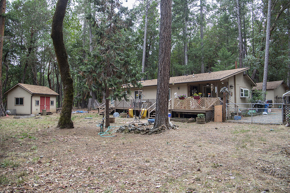 Attractive Frame-Built Home & Numerous Outbuildings on 5.10 Acres of Useable Property in Williams! The Main Home is Single-Level, with a Light Open Living Design, Cute Country Kitchen w/Pantry, & a Large Master Bedroom. The Full Length Deck makes for perfect Outdoor Living Space. This Property was once used as a School, & offers Several Nice Buildings that are all in Great Shape! The Buildings are arranged in an Orderly Fashion close by the Main Home, & include a Large Shop, Toolshed, Bunkhouse, Studio/Craft Room, & Gazebo! An Original Mobile Home is also on-site, Pre-dating Permitting, that could potentially secure a 2nd Dwelling Site for this Property. Several Carports, & Nice Pumphouse with Storage. This Property is still ideally set up to be used as a School, Wooded Retreat Center, or simply as a Personal Residence with Useable Outbuildings. Private-Off-Road Setting, with no Neighbors in Sight. The Land is Level & Useable & Heavily Treed with Marketable Timber. Lots of Value here!
