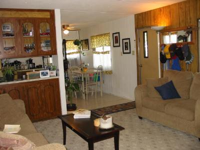 Clean and cute 2 bedroom home in all age park. Built in Hutch, Refrigerator, A/C unit and range/oven included. Nice shaded yard w/free irrigation in summer from TID. 3 year old supersealed roof. Some newer carpet and Vinyl. Space rent @280.00 includes sewer and rubbish