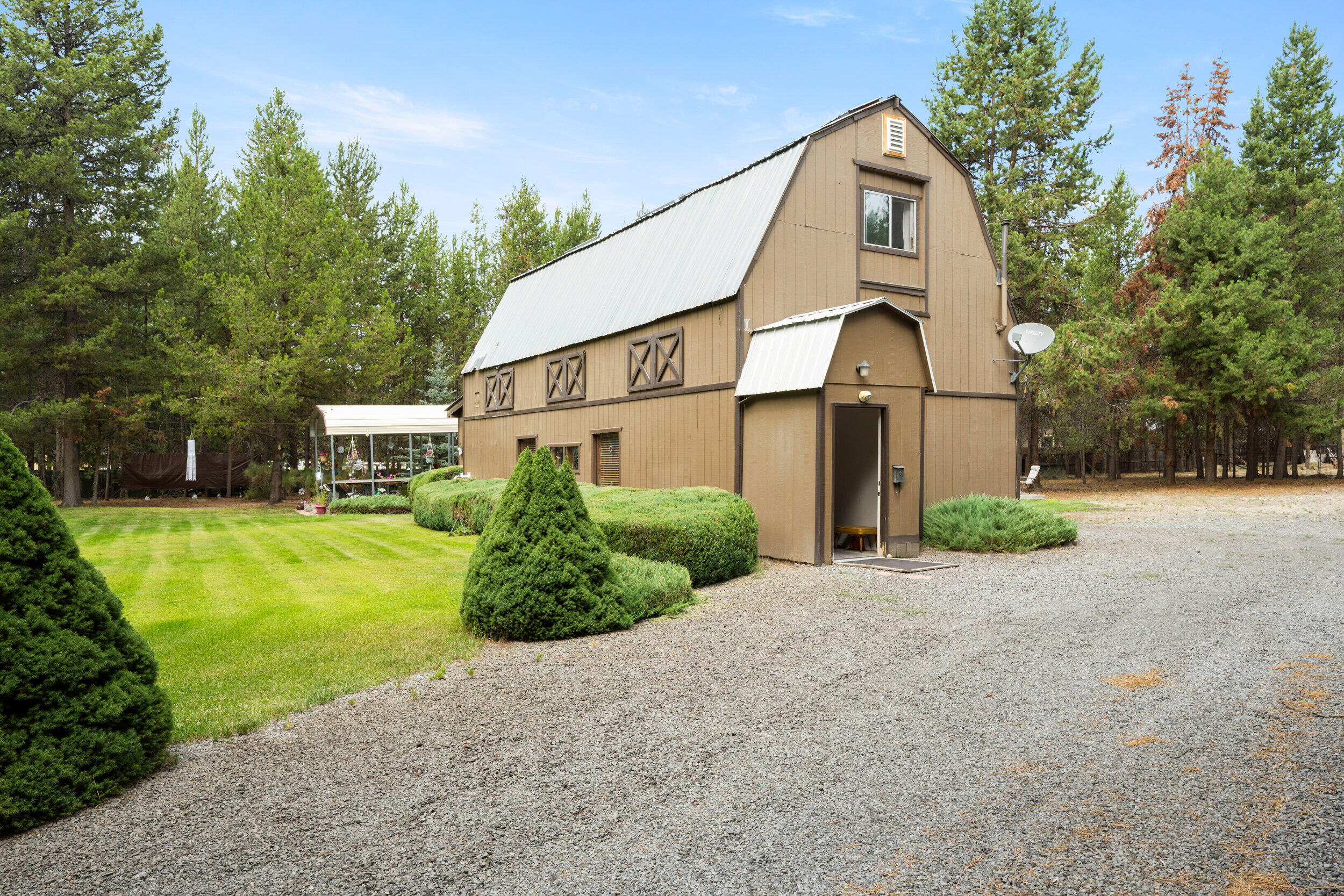 This unique, rustic, barn-style home in La Pine is a true gem! With 2 bedrooms, 2 bathrooms, and 1,454 square feet of living space, this home is packed with character and potential for any new homeowner. The property boasts a spacious living area, sunroom for relaxation, and a large living room upstairs. You'll love the beautiful landscaping, fully fenced and gated yard, and the convenience of a large one-car garage with a workshop. Other features include a designated covered RV shed, additional storage shed, and plenty of room for toys and other storage. This home is centrally located in La Pine, close to town's amenities like shopping and medical, a short drive to Highway 97, and a short distance to many outdoor recreational areas. It really is a must-see, so schedule your showing today!