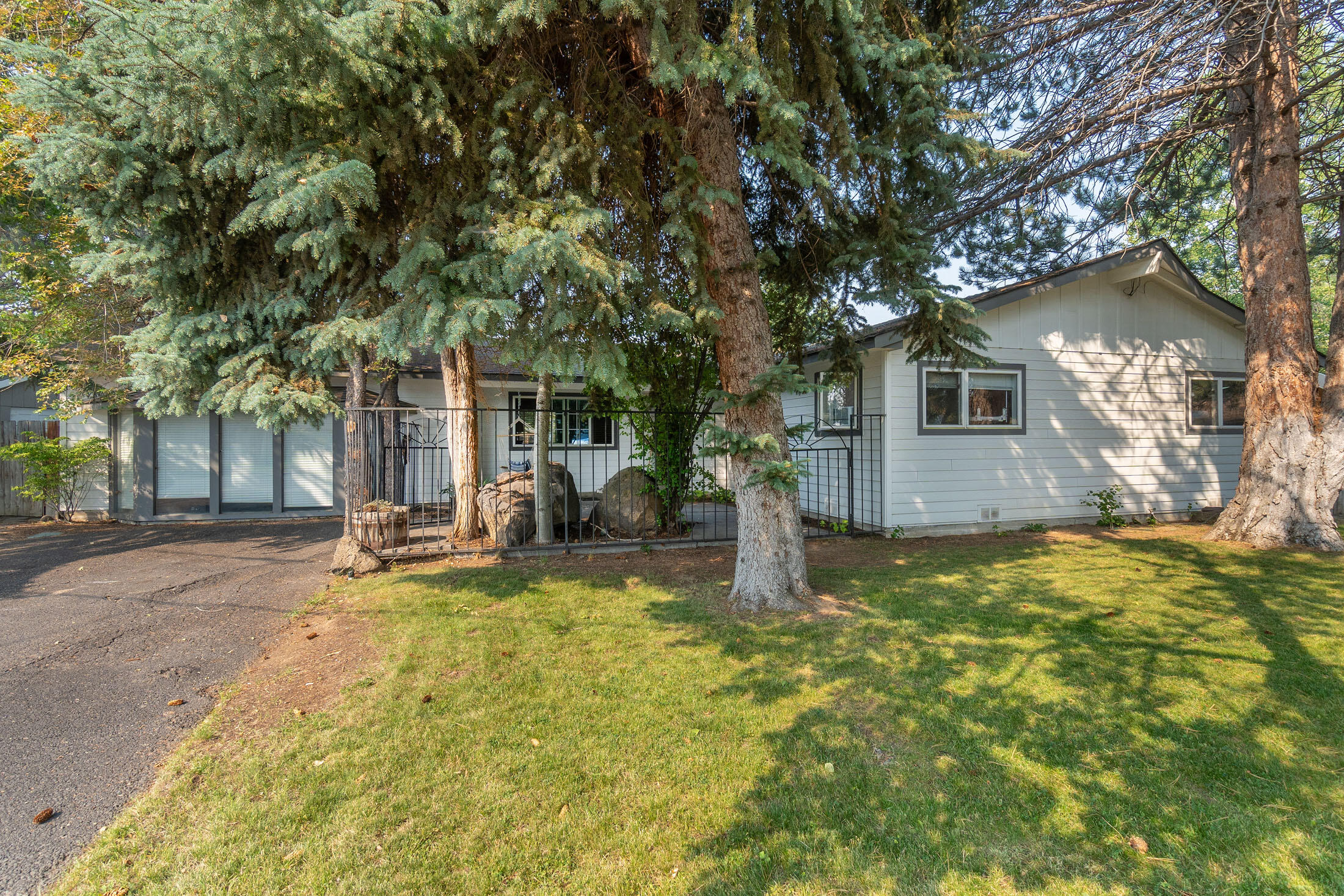 Must see home! This beautiful home sits on large corner lot in desirable NE Bend neighborhood. Close to park, schools, shopping. Home has 4 bedrooms, 3.5 baths with two primary suites. Large kitchen with lots of storage and pantry.  Breakfast nook and dining room. Formal living room with fireplace. Bonus room with half bath and plumbed for wet bar. Many interior updates, including Red Oak 1 flooring. New exterior siding and paint. Furnace and water heater replaced in 2020. Approved for ADU and short-term rental. Buyer to complete all due diligence on property uses. Large lot has amble room for garage to be built.