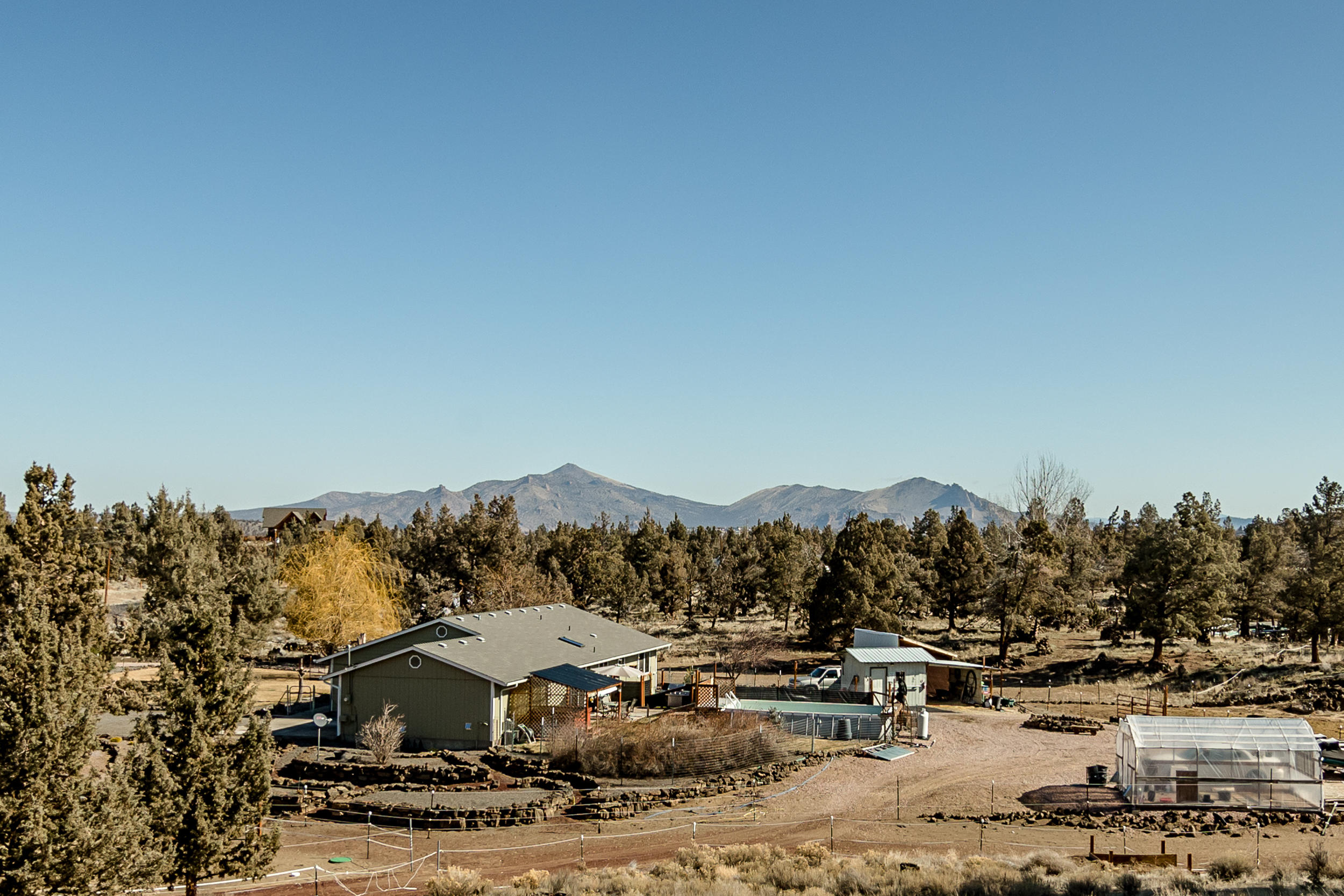 Come see everything this charming property has to offer! Great single level ranch home with vaulted ceilings. Updated flooring, kitchen, interior paint. Soak in the beautiful views of the surrounding terrain from the above ground heated pool, or relax in the spa as you enjoy the open solitude of the 4+ acres. Multiple outbuildings, Tuff Shed, steel shed, tack room with hay storage, greenhouse, horse stalls, water feature in front yard, zone sprinklers, canine agility course. Newer water heater, upgraded A/C, private well with newer pump and pressure tank as well as a Kinetico water filtration system. This property is ready for you to bring your hopes and dreams to the Central Oregon lifestyle!
