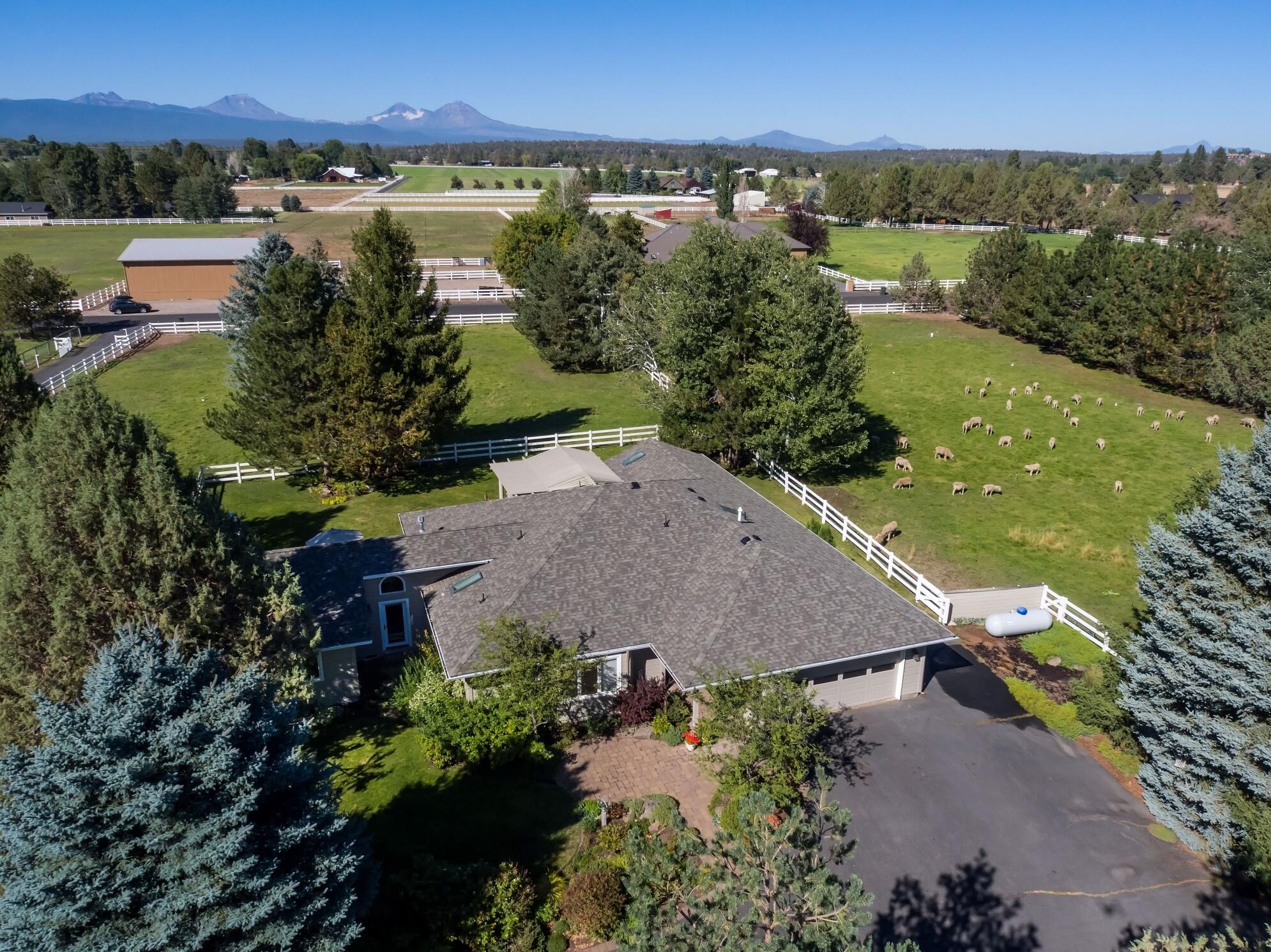 Tumalo Home on Acreage with Cascade Mountain Views. Traditional style, single level home is: 3207 square feet, 3 bedrooms, 2 bathrooms, living room with fireplace, updated chef's kitchen, family room with fireplace, office, master suite with jetted tub, utility room, attached two car garage. Private, beautiful, outdoor living spaces with a patio, decks to enjoy, the mountain views and mature landscape. Property includes: 5 acres with 3 acres TID water rights, fenced, gated, ready for livestock, Shop/Barn and livestock shelters. Wonderful opportunity to enjoy any Central Oregon Lifestyle!