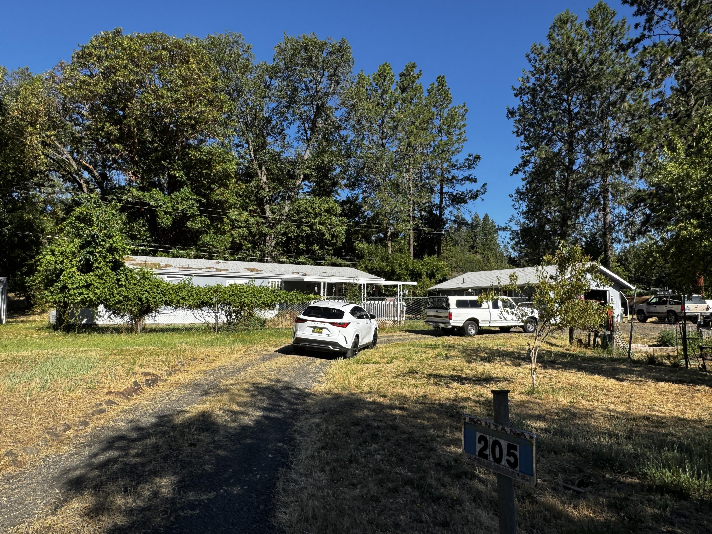 OPPORTUNITY!!!   This 3/2 home on over an acre is just waiting for someone ready to put in some cleanup.   Home is on a solid concrete block foundation, good well and city sewer.   Includes double deep 2 car garage with bathroom.  Lot has privacy in the back and a historic old barn with several sheds.   Tear out carpet, bring your paint and haul some debris off and you've got equity in the bank!