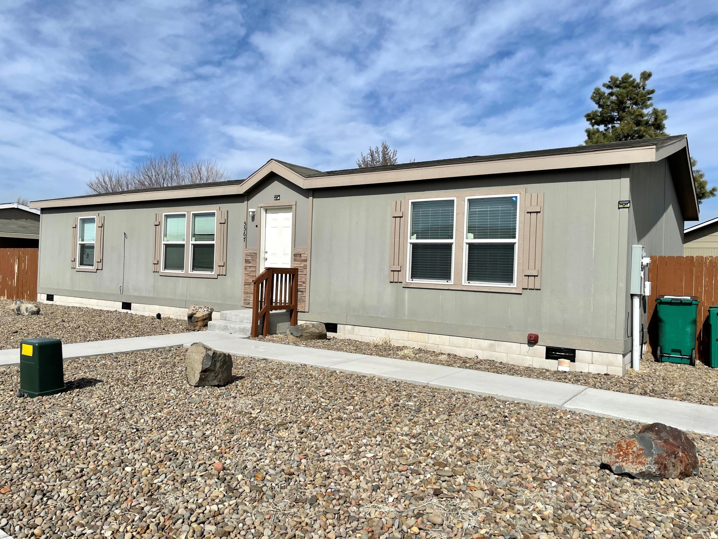Newer manufactured home in quiet neighborhood. This 3 bed 2 bath contemporary home sits on a double lot and has a large detached garage. Newer laminate floors throughout. Book your showing today!