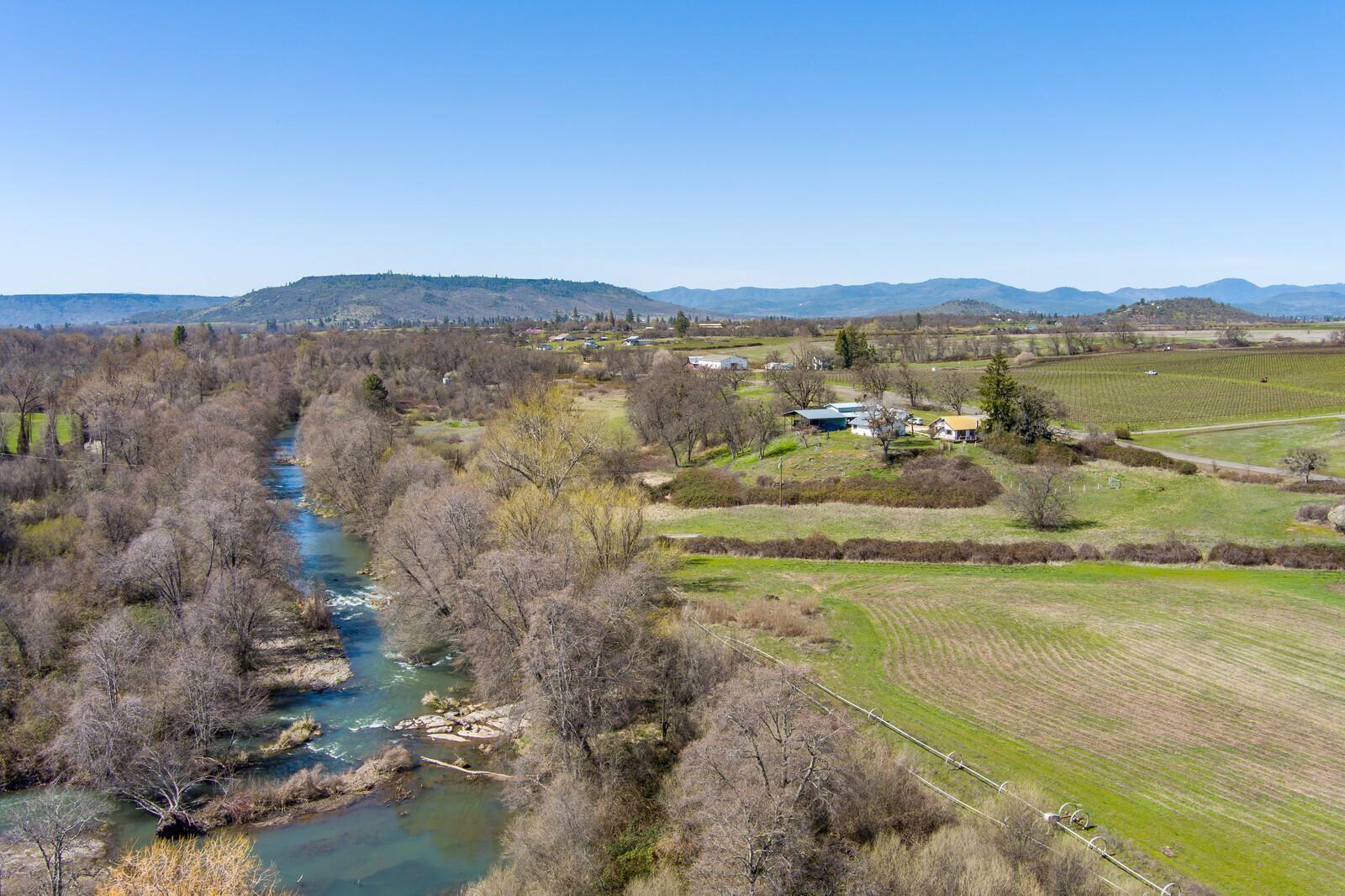 VERY RARE SENIOR PRIORITY STATE WATER RIGHTS from 1899! Located on the outskirts of town, adjacent to Agate Ridge Vineyard, and Little Butte Creek running behind it, this unique property offers incredible views and endless opportunities! With 2 tax lots, water rights/irrigation, and gently sloped acreage, this property could easily serve many uses such as a picturesque wedding/corporate venue, bed-and-breakfast, family ranch or vineyard, as it has all the basic infrastructure in place. The cute little farmhouse has several financing possibilities such as a rehab, land, private or construction loan. This property also features a partially converted garage w/parking for 1 car and 2 large rooms that could be used for extra living space or as a great hobby room. The spacious barn has power, 50amp RV outlet, a small workshop area, 1 stall w/covered space for future stalls or storage for machinery, and is equipped w/a feeding station. Buyer's to conduct due diligence regarding intended use.