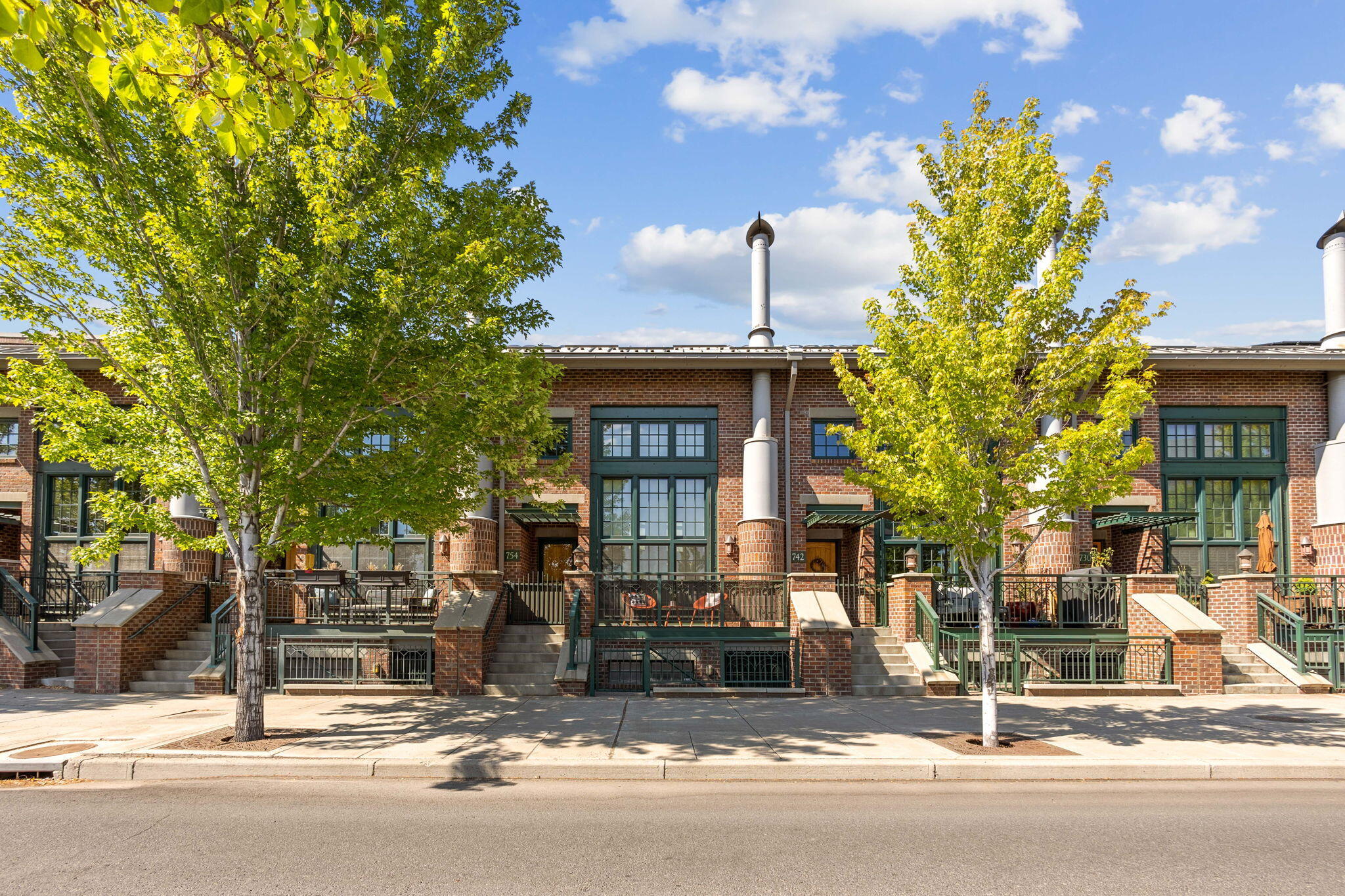 Truly unique and highly desirable brownstone in Bend's Mill Quarter near the Old Mill and Box Factory. Exceptional location close to restaurants, shops, breweries, parks, trails, and concerts. This special home has an elevator to make life easier in the long term. Feel as if you're living in the big city with soaring ceilings and open beam/ductwork in the great room. The kitchen features Viking stainless steel appliances including a built-in refrigerator, 6-burner gas range, and oven w/ warming drawer, plus custom cabinetry, granite countertops, and subway tile backsplash. Large main level bedroom has courtyard views, a full bathroom with tiled floors, counters, and walk-in shower, and a walk-in closet. The upper level has a loft, primary bedroom with full bathroom incl. dual sink vanity, and walk-in closet. The lower level has separate access, an additional bedroom and full bathroom, and has amazing potential for a work from home situation.  Don't miss this one!