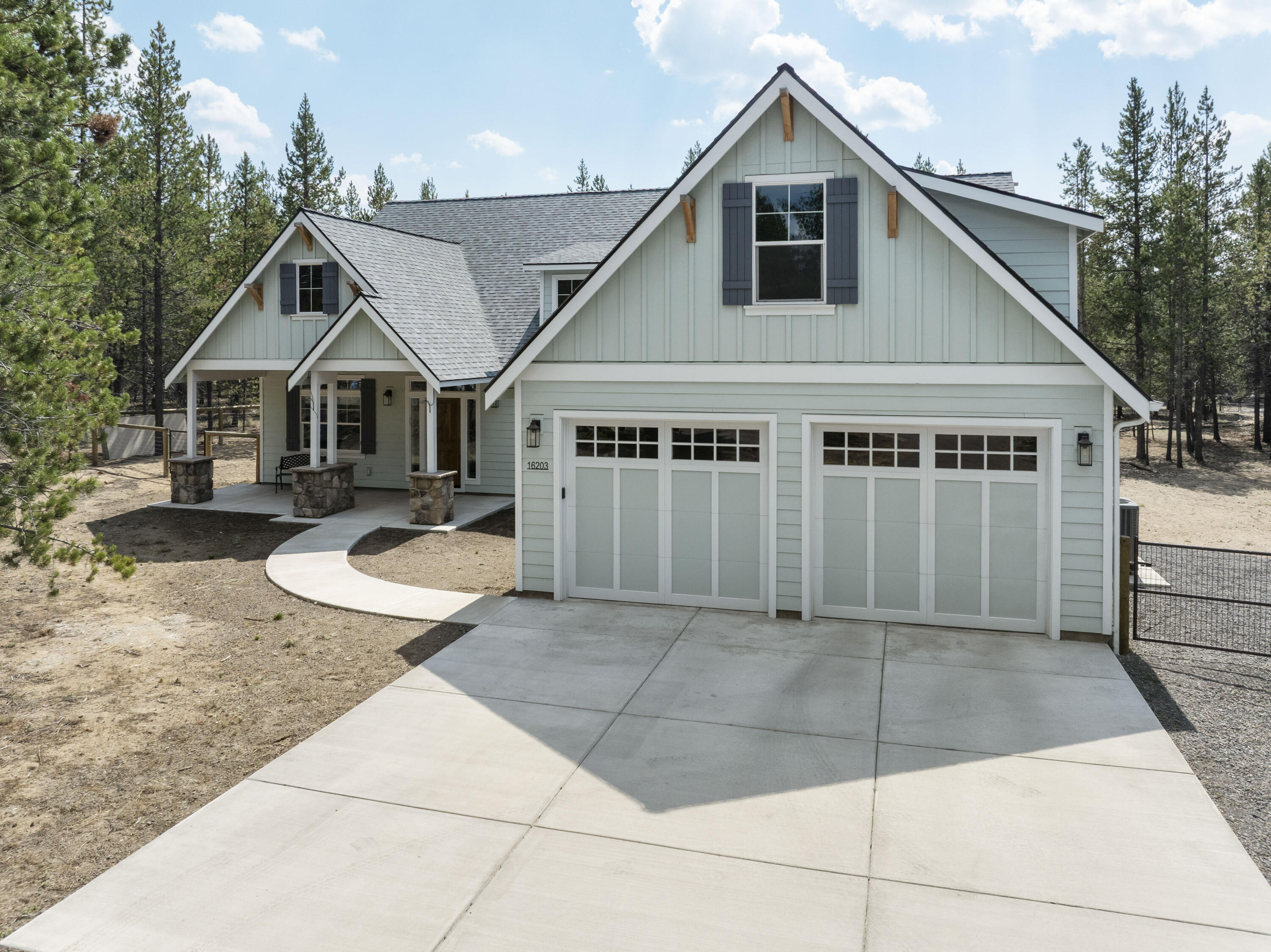 Nestled on 1.01 acres with direct access to La Pine State Park, this thoughtfully designed 2022 single-level home blends comfort & craftsmanship. The open great room showcases vaulted ceilings, a gas fireplace with floor-to-ceiling stone surround, & engineered hardwood flooring. The chef's kitchen features knotty alder cabinetry with pull-outs, upgraded stainless appliances including a 6-burner dual fuel range, drawer microwave, and a custom walk-in pantry with shelving & mini-fridge. The primary suite is a private retreat with radiant-heated tile floors, double vanity, & a curbless glass-enclosed shower. Additional highlights include custom closets in every bedroom, office, mud room & laundry room, attached workshop and a finished double garage with attic storage. Outdoors, enjoy a large covered patio with knotty pine ceiling, propane quick-connects, full RV hookups, & fully fenced backyard. Newer septic and private well complete this exceptional property.