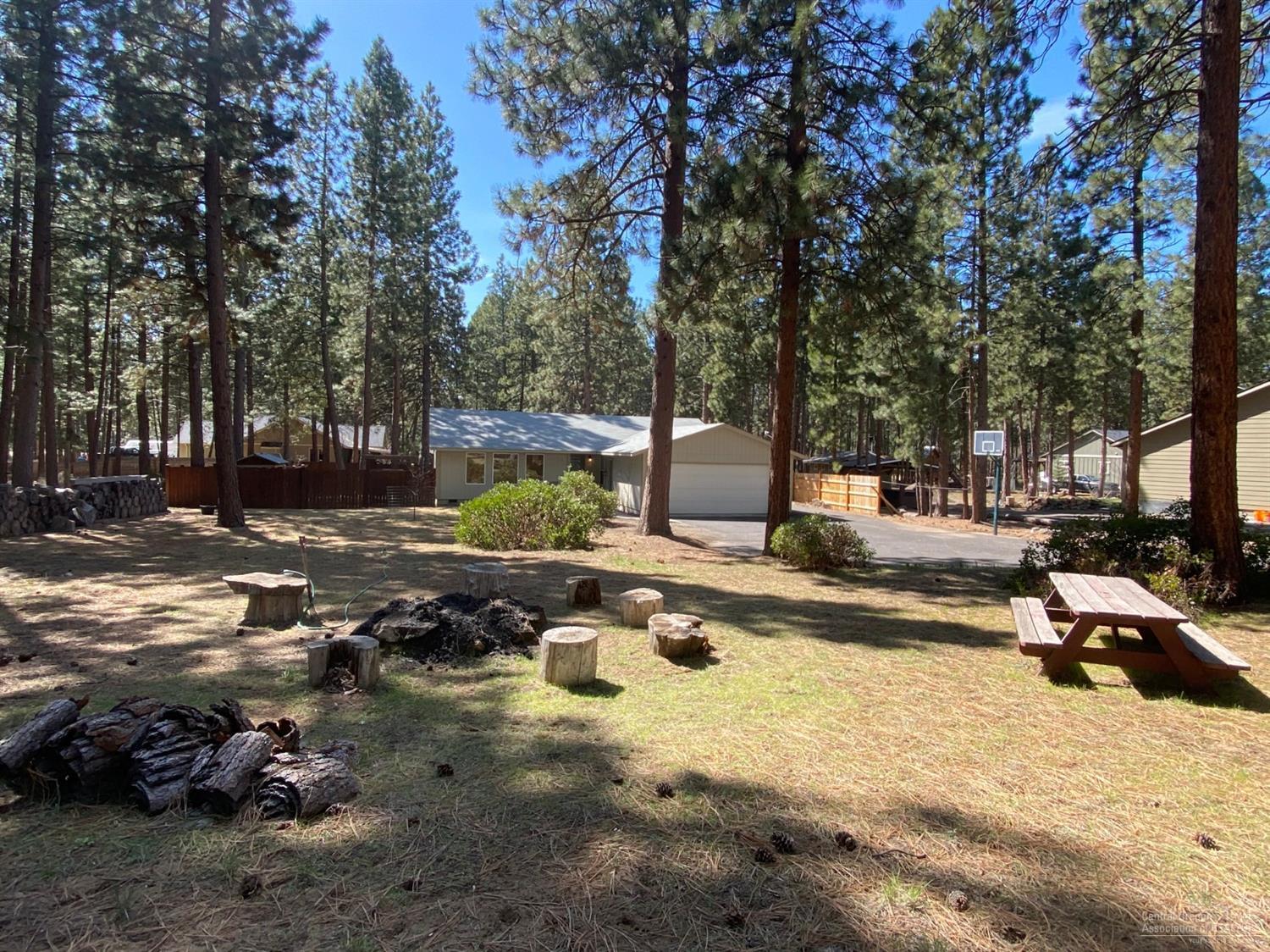 Tucked into the beautiful mature pine treed 0.59 acre lot is this gorgeous single level home with loads of upgrades and updates. Granite counters, stainless steel appliances, undated bathrooms, light fixtures, flooring, trim and more. Ready to go! Nicely fenced back yard, plus a separate fenced in area for the kids with play structure, hot tub sitting under a gorgeous pergola, nice big trex deck, Paved street, and also paved driveway, with RV /Boat parking. Don't miss this beautiful home! Area a nice homes in SW Bend.
