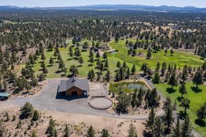 Welcome to a place where 17.49 pristine and unspoiled acres of natural beauty and exquisite craftsmanship meet in the most harmonious way. Once inside the gate, a world of unique beauty and splendor awaits at this private hilltop escape offering commanding views of the Cascade mountain range to the west and Pine Mountain to the east! Situated less than 10 minutes from downtown Bend, this spectacular retreat is secluded yet very accessible. The 3-bedroom, 2-bath, 1988 sq ft home was thoughtfully designed to maximize the topography and the setting. Quality workmanship and gorgeous materials create inviting living spaces with grand views that welcome the outside in. The barn consists of 4 stalls, 1 foaling stall, heated tack room, double office, heated finished storage with work bench, enclosed hay/equipment storage, RV parking, domestic water, paddocks, fenced pasture and a round pen. Fall in love with the serenity of the space and add your name to the legacy of the land.