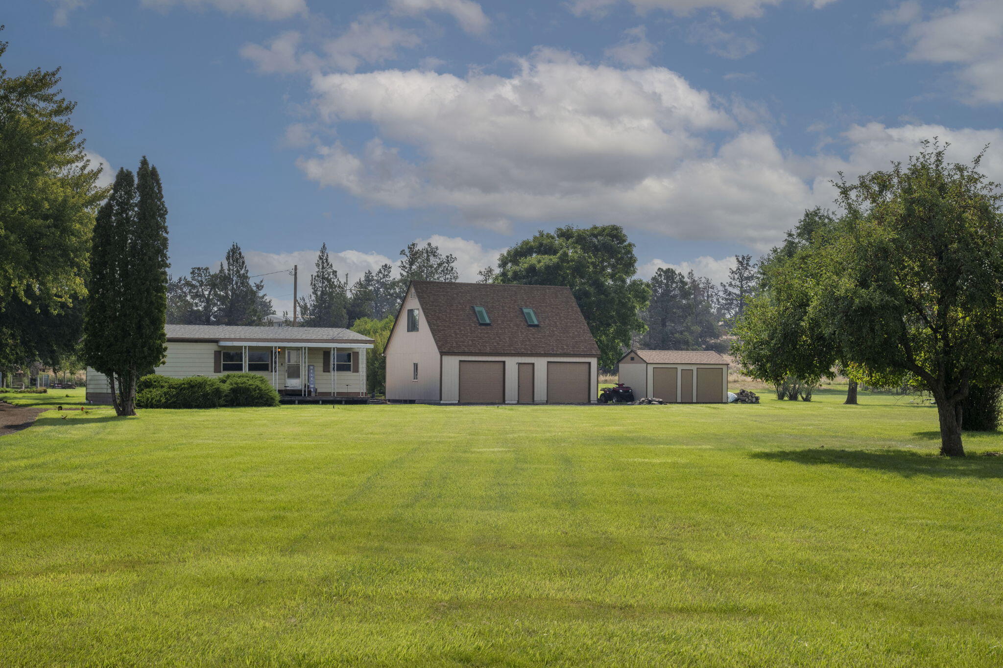 With Cascade views, irrigation rights, and plenty of privacy, this property has lots to offer. Sitting on just over 2.5 acres and located on the NE side of Redmond, this home will make you feel like you're out in the country while still being close to all of the amenities that Redmond has to offer. Situated roughly in the middle of the lot, this cozy 2-bed 2-bath home has privacy from the road, backs up to the canal toward the East, and offers mountain sunsets to the West. Pride of ownership is apparent both inside and out. Minor updating throughout the house including flooring, windows and appliances. The 2-car detached garage/shop and the outbuildings provide plenty of room for all of your cars, toys, boats, etc. The bonus room above the garage is the perfect space for an
 office, jam studio, workout room, lounge zone, or just storage.  Schedule your showing today.