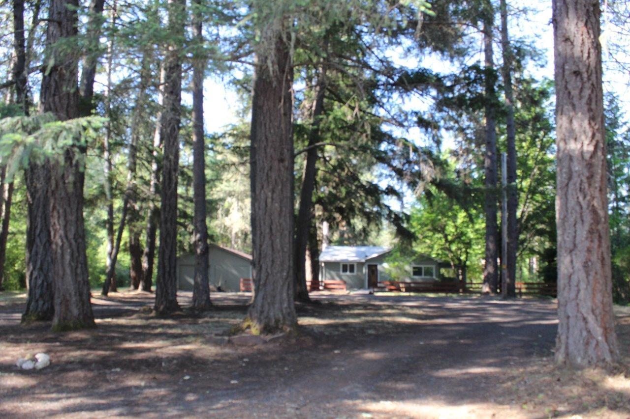 Big Timber Setting. 3.53-Acre with charming 3-bedroom, 2-bathroom home built in 1961. Remodeled in 2018 with floor covering & new bathrooms. 1,585-Sq. ft. includes separate 1-bedroom, 1-bathroom building. Vaulted knotty pine ceilings, fireplace, 20x20-garage, 12x15-storage shed, good well and water rights per owner. Close to the Rogue River and Lost Creek Lake recreation.