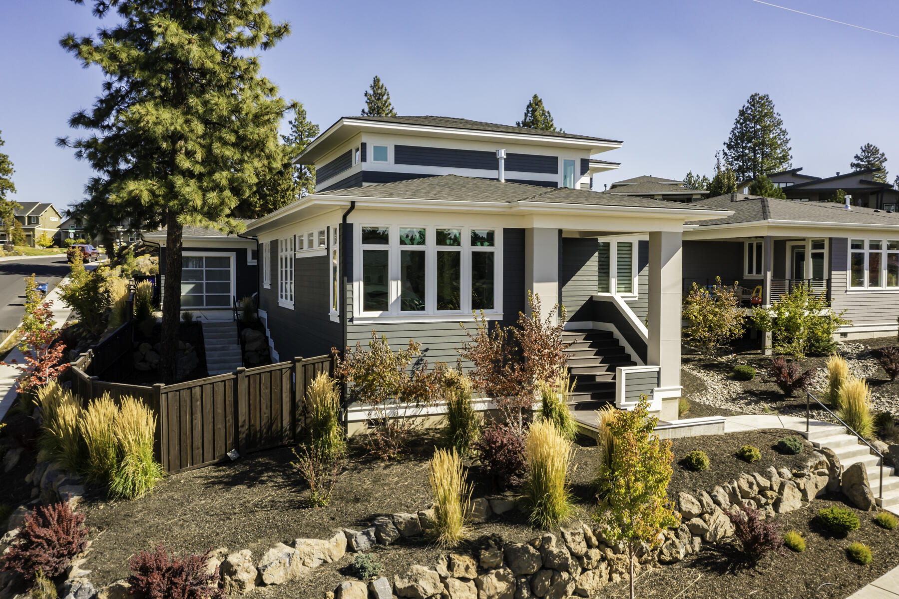 Take a look at this stunning home in Shelvin Bluffs with breathtaking mountain views. Located near Shevlin Park's walking and biking paths, this home features an open kitchen, dining, and living room area with floor-to-ceiling concrete tile, stained wood beams, a built-in TV cabinet, and a modern gas fireplace. The kitchen is equipped with a 48'' professional-grade stainless gas range, brown alder cabinets, and quartz counters. The main floor includes an office and a master bedroom with a large en-suite bathroom. The master suite boasts its own private patio that is wired and ready for a Hot Tub. Upstairs, features a bonus room and two additional bedrooms, each with their own full private bathrooms and walk-in closets. Custom Epoxy garage floors, EV circuit, and third garage door opens to the main entertaining area of the backyard with established landscaping for pets and guests to feel right at home.  This lightly lived-in home is move-in ready and won't last long!