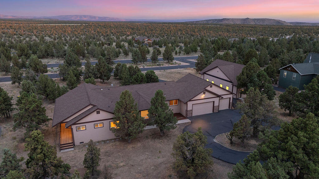 2,000 sq ft Hangar/Shop! This unique property in the gated Dry Creek Airpark is built with insulated concrete forms (ICF) for strength and energy efficiency. The 2,716 sq ft main level offers 4 bedrooms, 2.5 baths, and an open living area with vaulted ceilings, propane fireplace, and expansive windows. A den and oversized laundry/mud room add convenience, while the primary suite features a walk-in closet and spa-like bath. A 699 sq ft daylight basement—accessible from the 3-car garage—is plumbed for a bath and ready to finish. The standout 2,000 sq ft hangar/shop is plumbed for a bathroom and offers flexible use as a workshop, hobby space, or RV/boat storage, with the added bonus of access to a private, paved, lighted 3,000-ft airstrip.